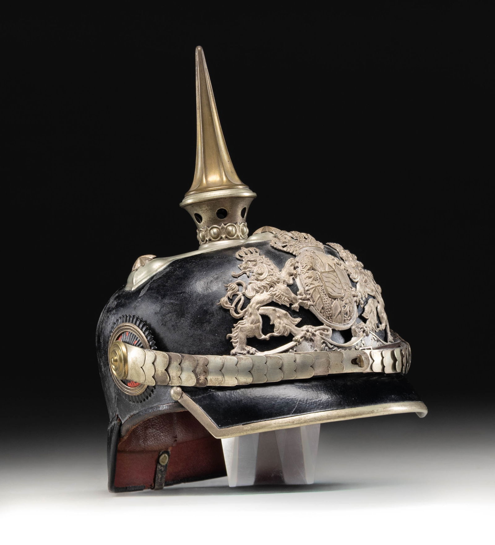 M1897 BAVARIAN SILVER TRIMMED OFFICER'S SPIKE: HELMET.A beautiful imperial German officer's spike helmet from Bavaria. The helmet stands about 10 1/2" in height and measures about 9 3/4" front to back. It shows a slivered spike with a gilded top s