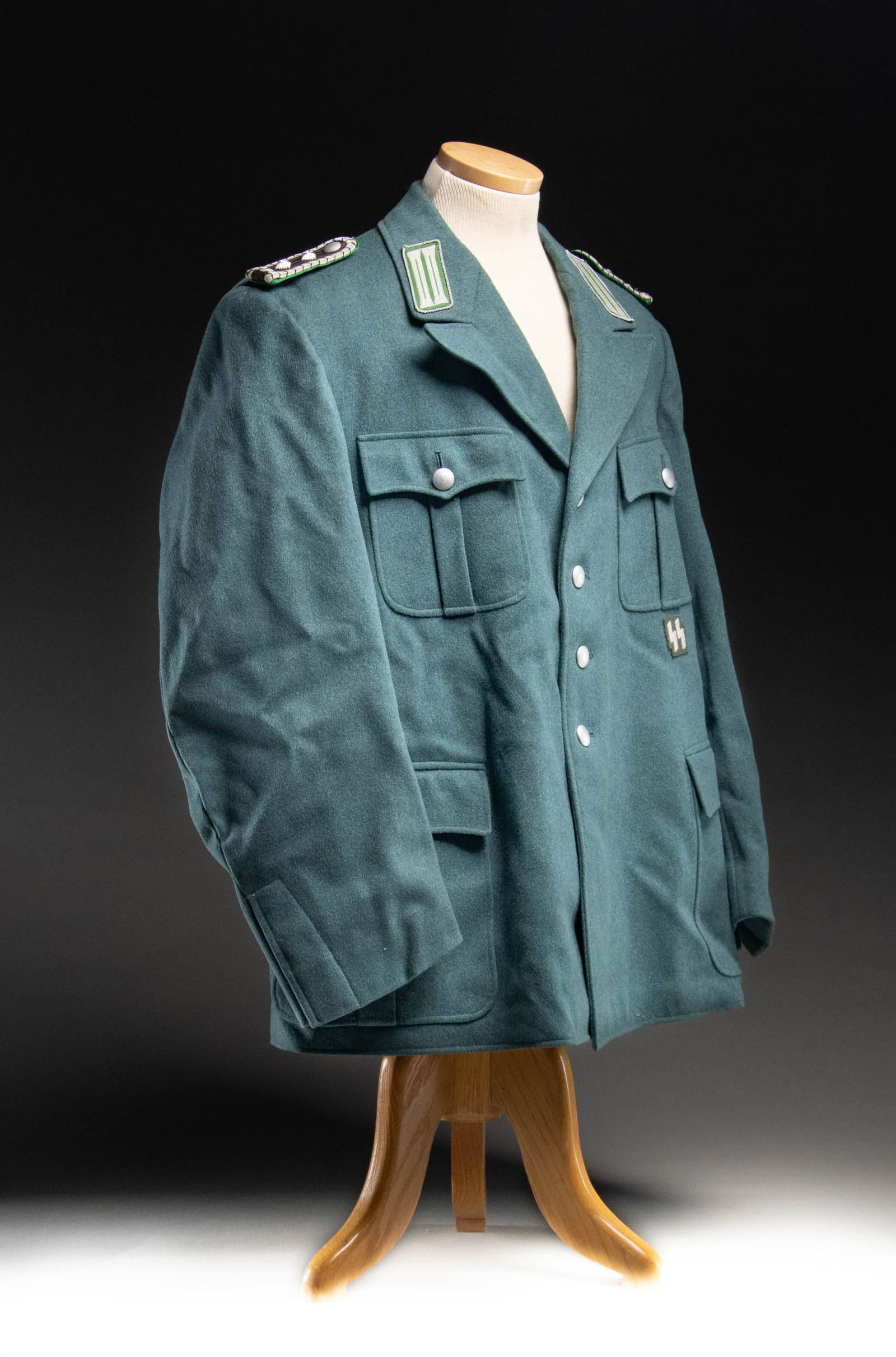 WWII GERMAN POLICE UNIFORM FOR A HAUPTWACHTMEISTER: A finely tailored WWII German uniform for a Police Hauptwachtmeister of the Schutzpolizei d. Reiches. The deep sage green coat has bullion trimmed green collar tabs with brown & silver shoulder straps