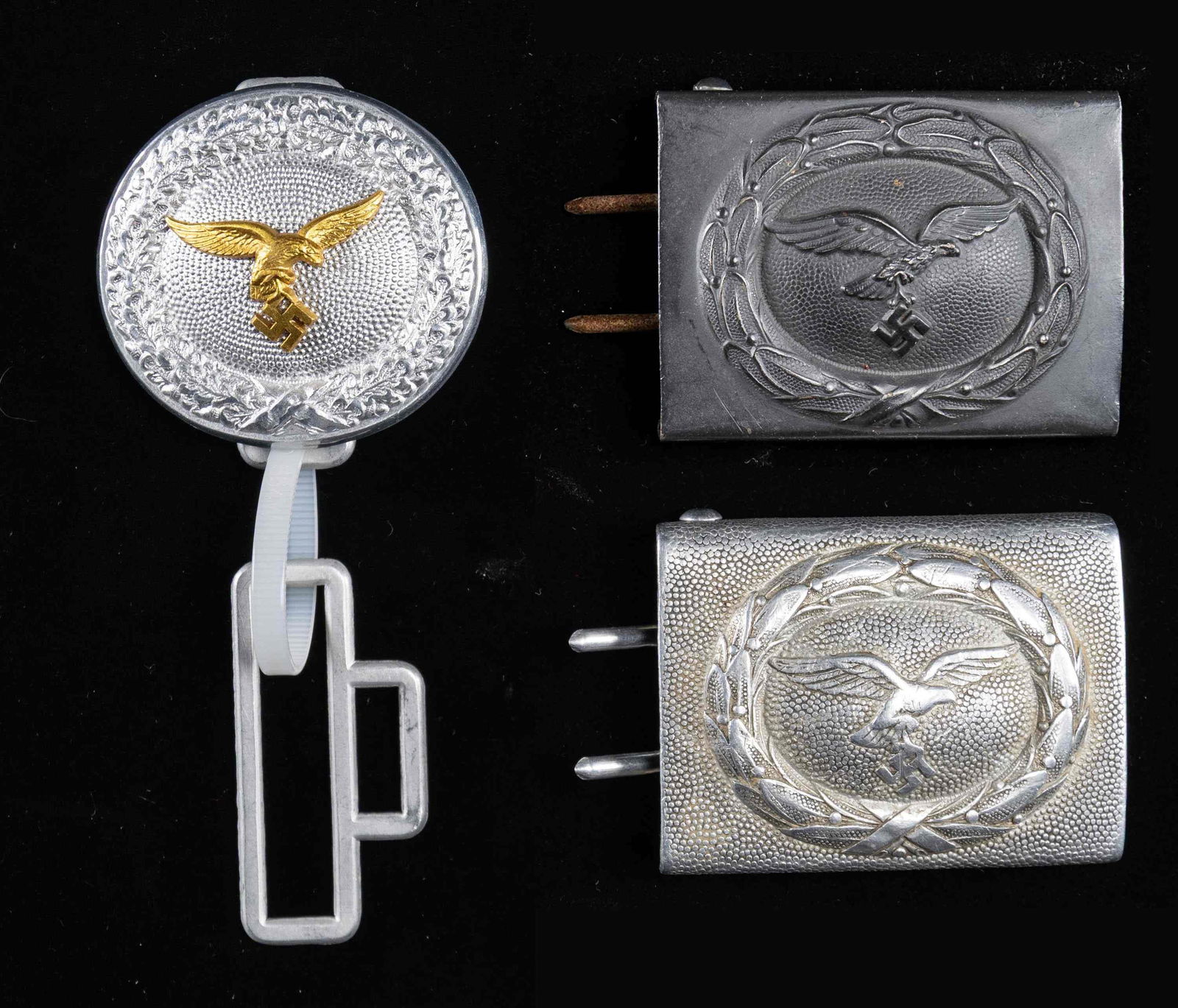 3 WWII GERMAN LUFTWAFFE BELT BUCKLES.: This lot contains 1 Luftwaffe officer's belt buckle with a gold finished eagle on an aluminum field complete with keeper,1 Luftwaffe enlisted buckle in aluminum, and 1 Luftwaffe enlisted buckle in ste