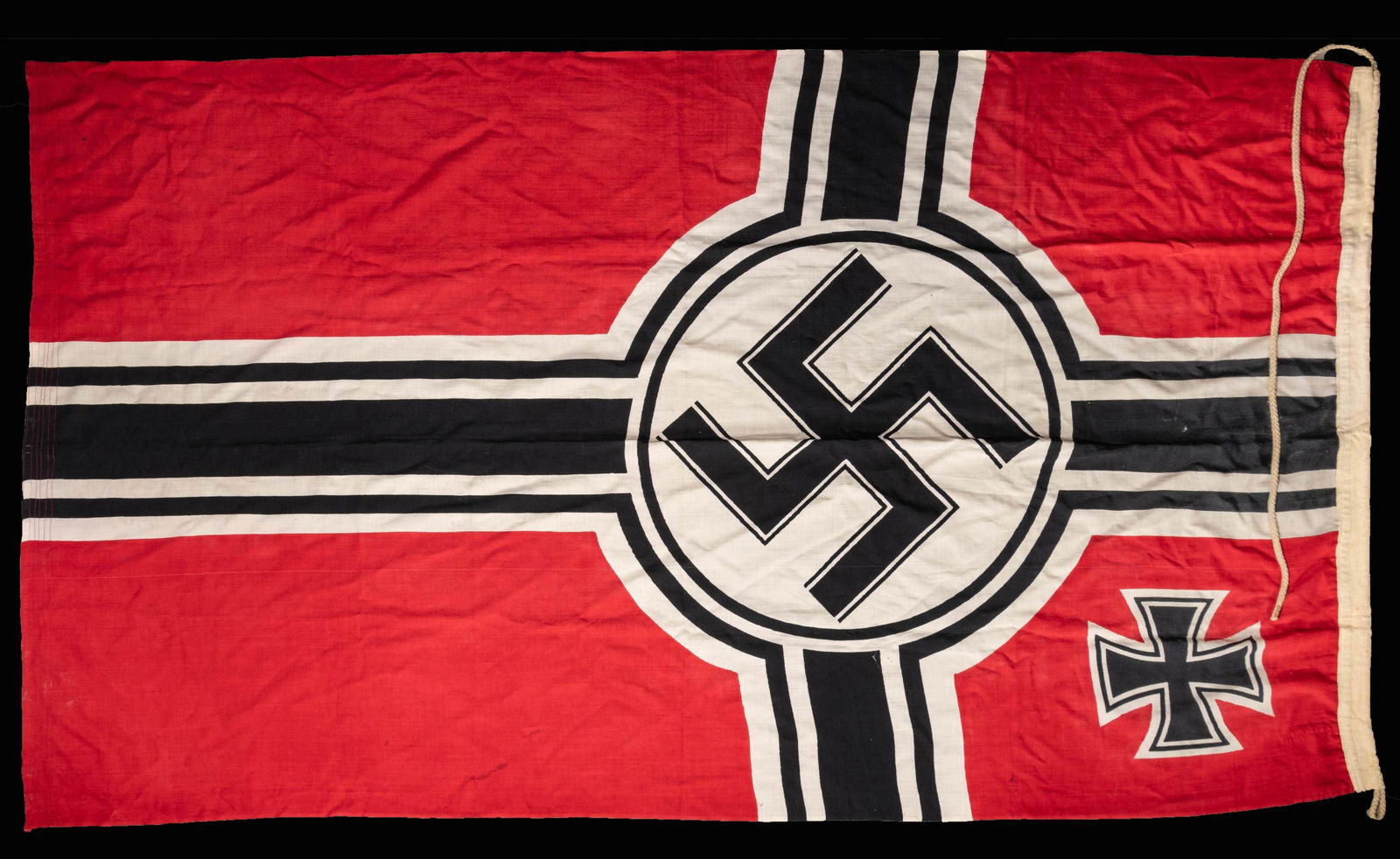 WWII GERMAN KRIEGSMARINE BATTLE FLAG.: This WWII German Kriegsmarine battle flag measures approximately 54" x 101". The battle flag is of standard design and is marked on the hoist "(eagle) M Reichskriegsflg. 1.5 X 2.5". The flag has an in