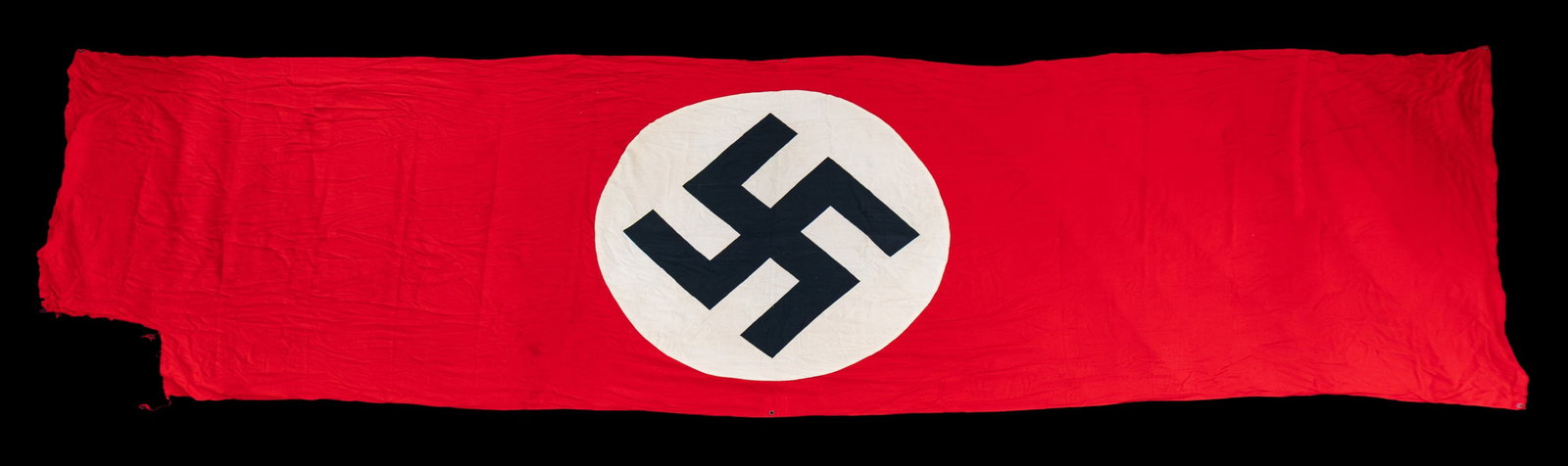 LARGE WWII GERMAN PARTY BANNER.: A large WWII German Party banner measuring about 184 1/4" x 55". The banner is of standard form, style and colors. CONDITION: This flag is relatively solid but is torn on one end likely from being tor