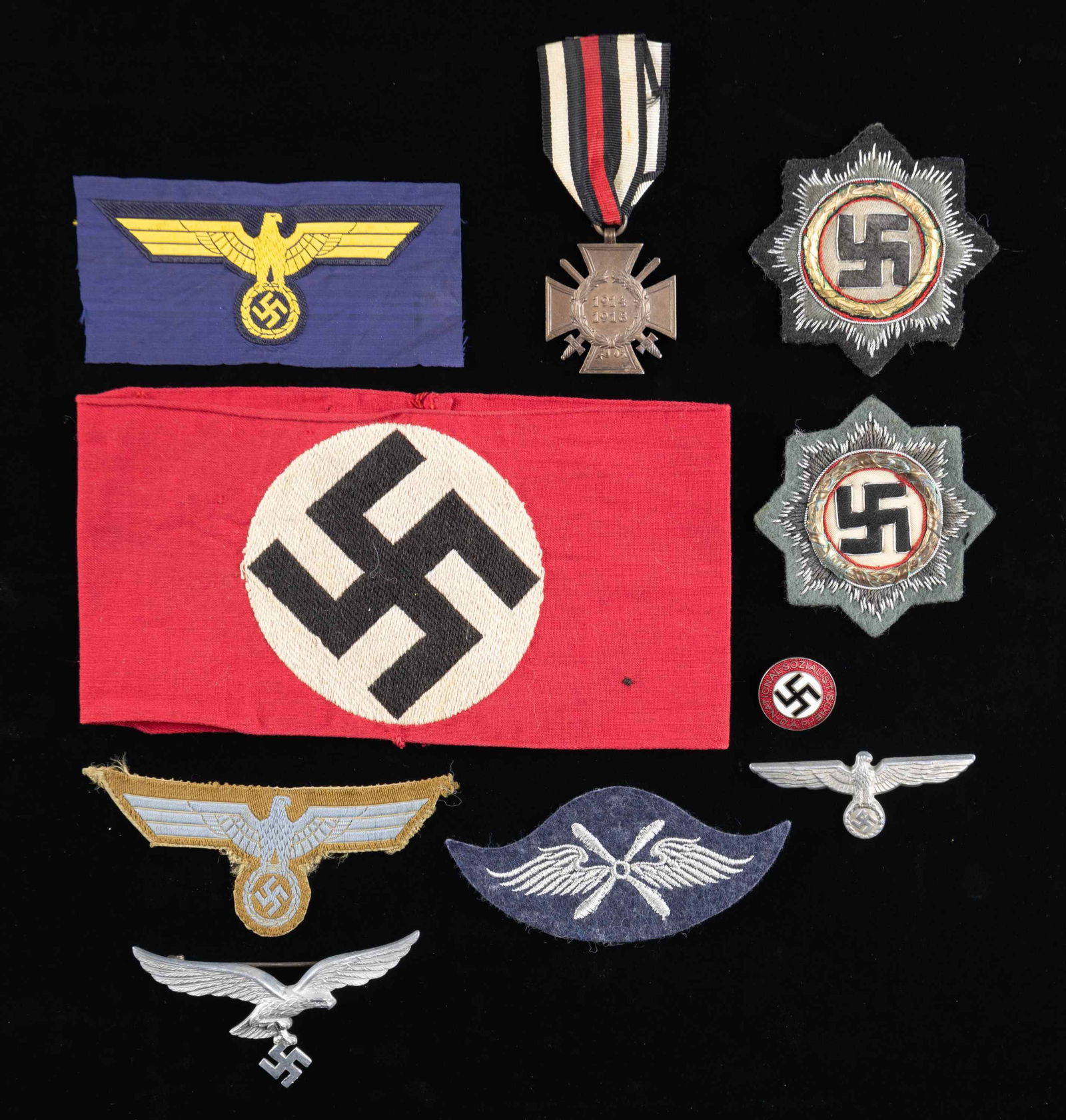 WWII GERMAN AWARDS, EAGLES, AND MORE.: This lot of WWII German items includes 1 embroidered style Party armband, 1 bevo sewn Kriegsmarine breast eagle, 1 Wehrmacht Afrika Corps breast eagle, 1 aluminum Army cap eagle, 1 aluminum Luftwaffe