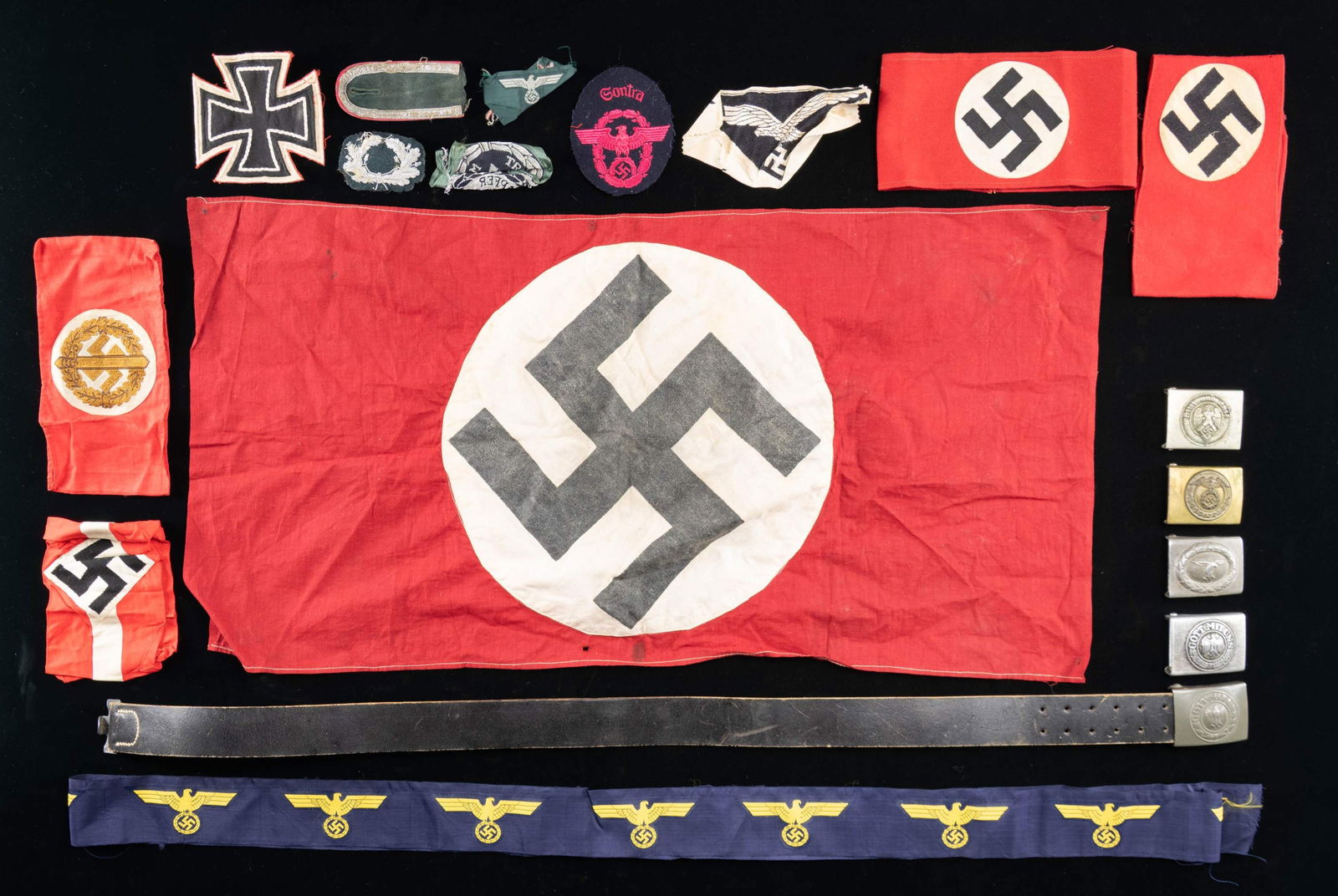 WWII GERMAN CLOTH AND BUCKLES.: This expansive lot includes 1 HJ armband, 2 Wool Party armbands, 1 SA Wehrmannschaft armband, 1 uncut unissued roll of 16 enlisted Coast Artillery breast eagles, 1 small Luftwaffe sportshirt eagle, 1