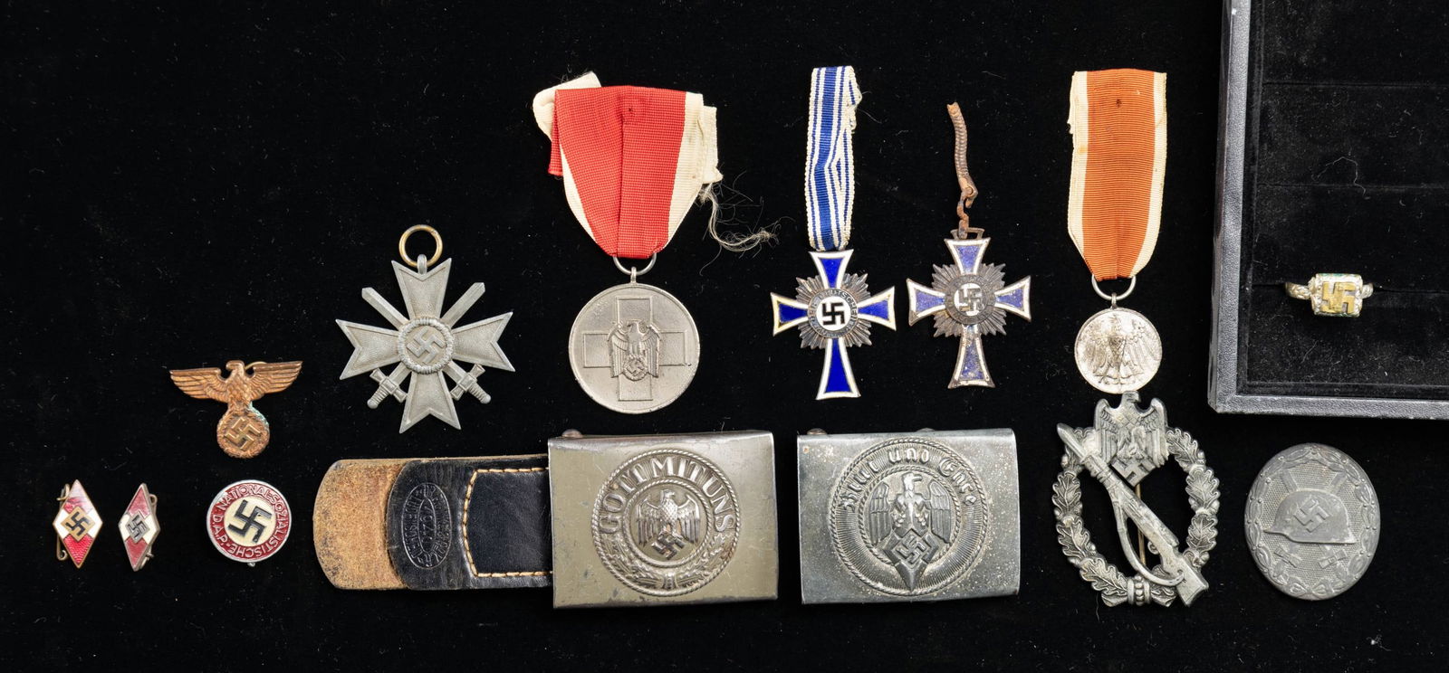 WWII GERMAN BUCKLES, MEDALS, BADGES, AND MORE.: This assorted lot of WWII German artifacts includes 1 Army belt buckle, 1 HJ belt buckle, 1 Silver Wound Badge with a zinc finish, 1 Late war painted Party pin, 1 Bronze Mother's cross with a short ri