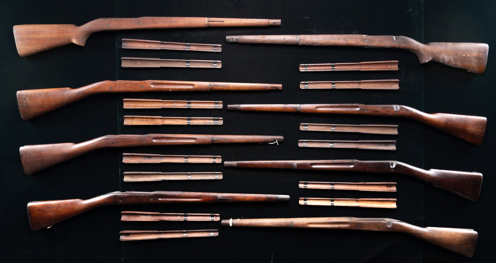 GROUPING OF 8 U.S. MODEL 1903 SPRINGFIELD BOLT: ACTION RIFLE STOCKS AND 14 HANDGUARDS. These stocks were removed from rifles & most have arsenal rework finishes, or finishes that are in some stage of restoration. The stocks have seen extensive use