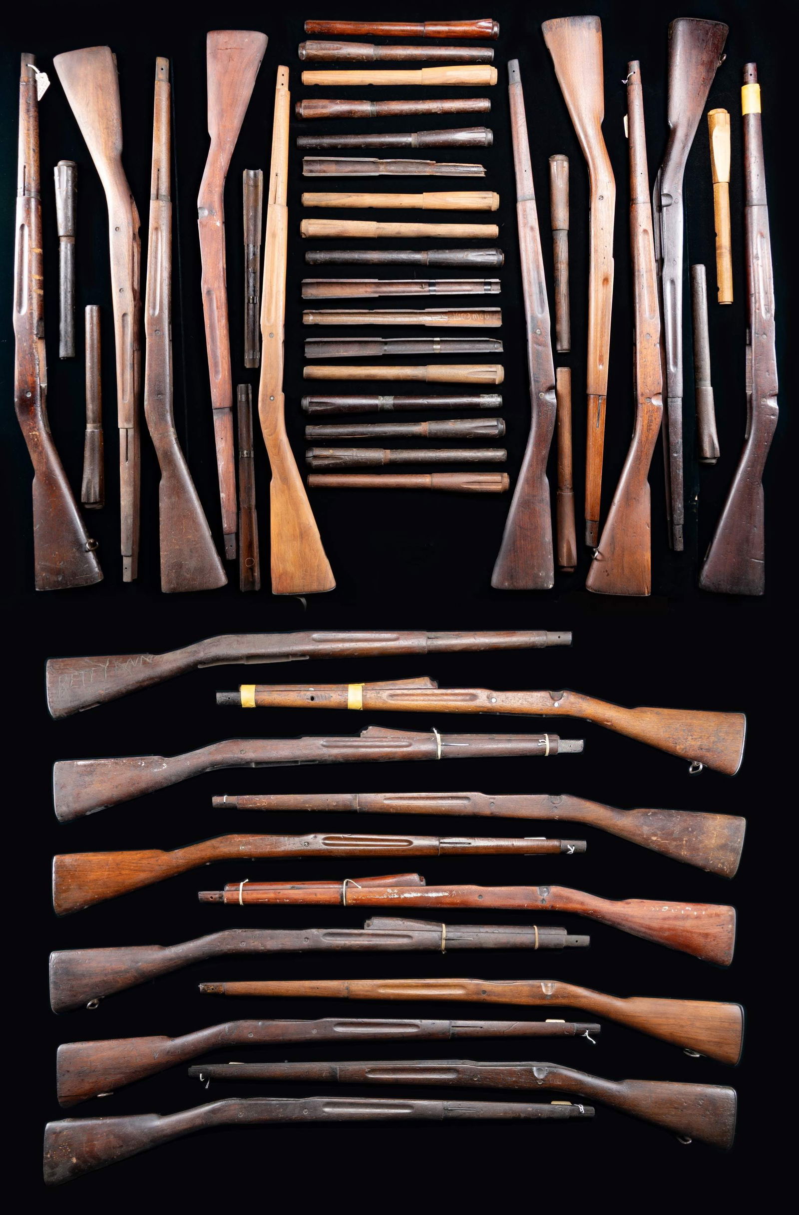 LARGE GROUPING OF 21 U.S. MODEL 1903 SPRINGFIELD: RIFLE STOCKS AND 25 HANDGUARDS. The stocks are all walnut, S-type & straight grip. These stocks were removed from rifles, having seen extensive hard service & may have been through previous overhauls.