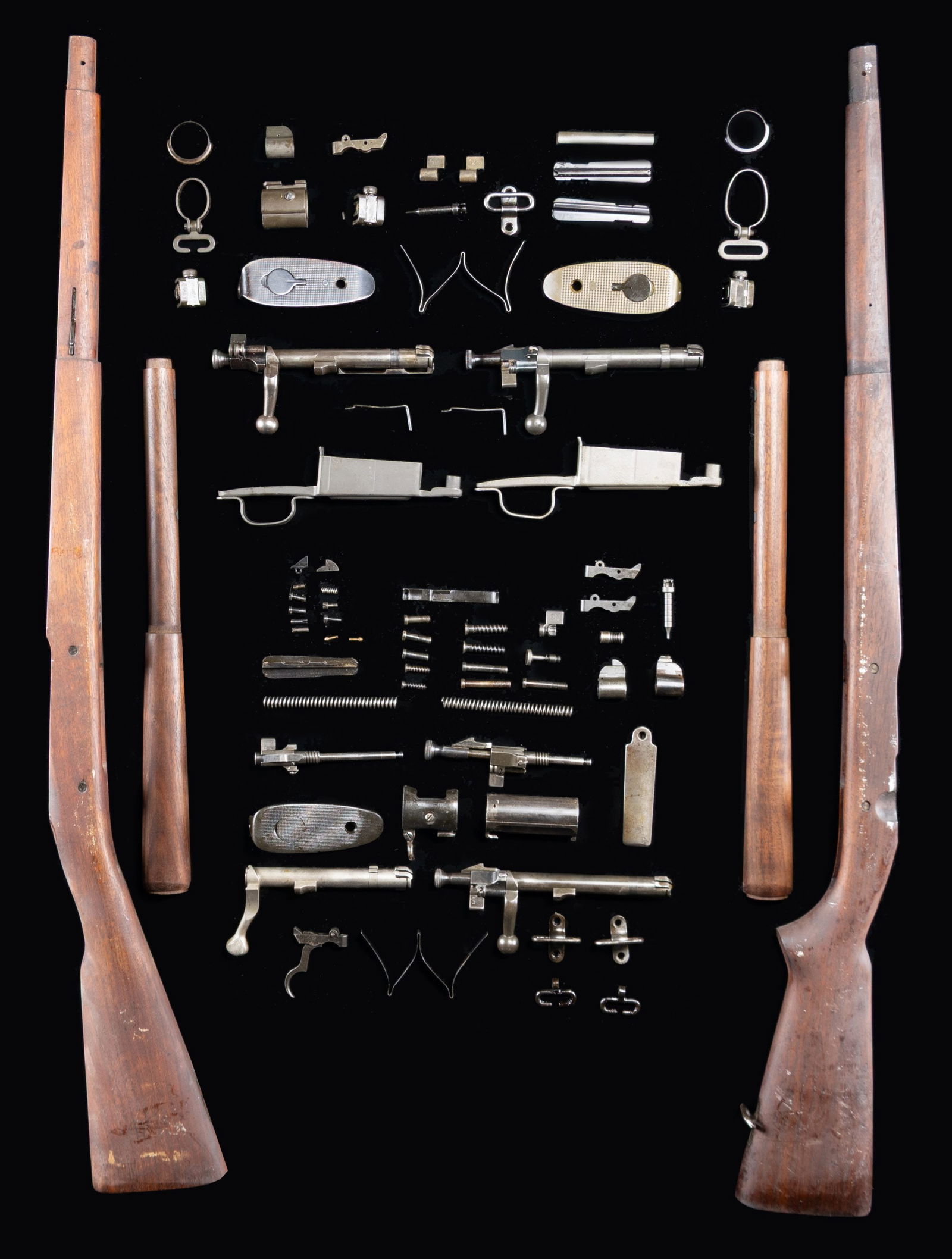 GROUPING OF US MODEL 1903 & MODEL 1903A3 BOLT: ACTION RIFLE STOCKS AND PARTS. Stocks include model 1903A4. Buttstock is marked in cutoff recess w/ "K". Stock made w/ two recoil bolts & has the correct cutout for bolt handle. Stock includes milled