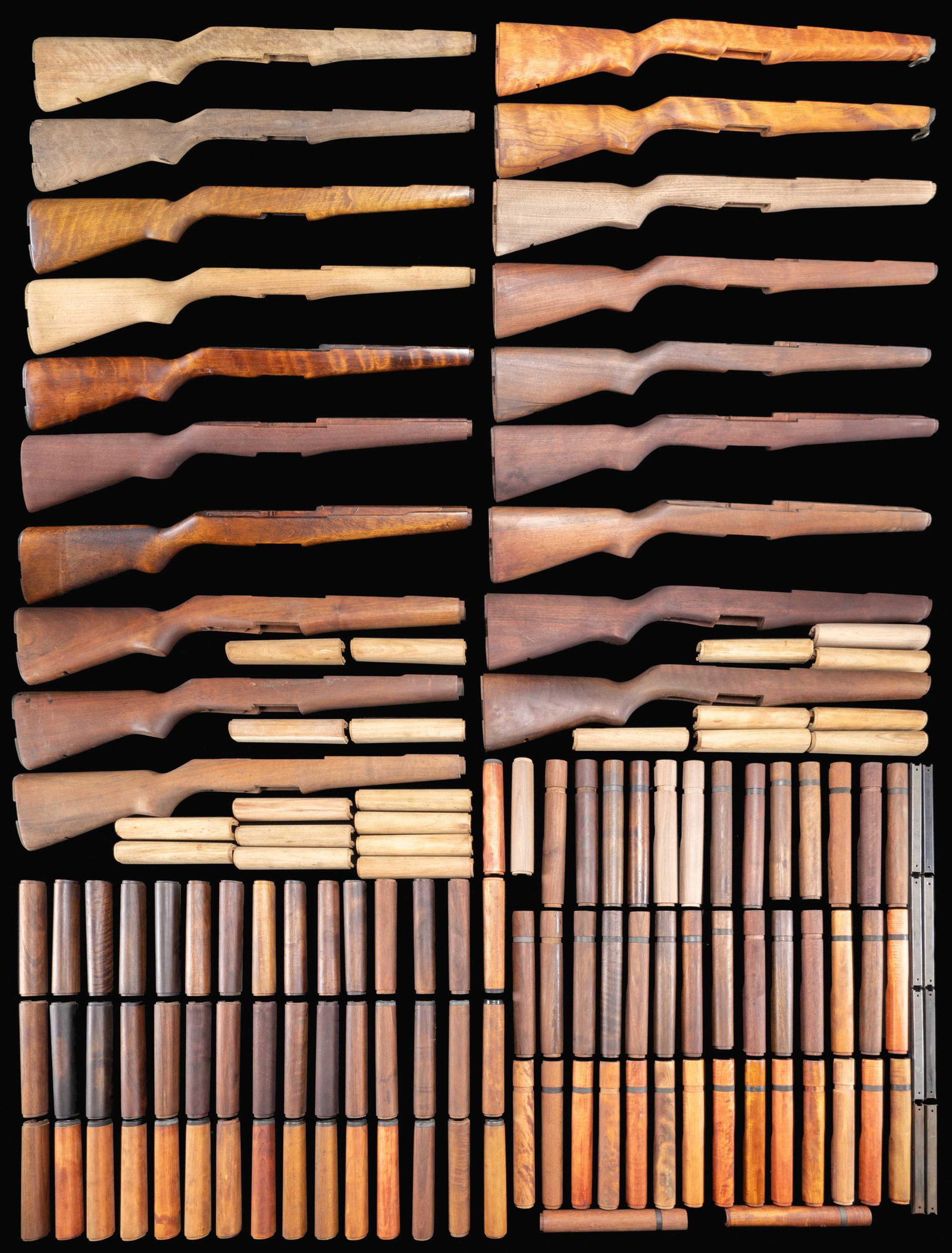 VERY LARGE GROUPING OF REPLACEMENT M1 GARAND: BUTTSTOCKS, FRONT AND REAR HANDGUARDS. 19 buttstocks are walnut, 6 are hardwood. Stocks are mostly unmarked & have varying degrees of finishes, of which many are arsenal rework, ranging from unfinishe