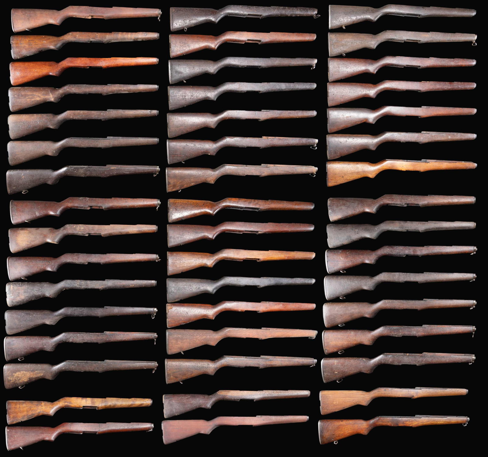 GROUPING OF 48 M1 GARAND RIFLE BUTTSTOCKS.: These buttstocks are nearly all walnut & unmarked. Many retain some of their original metal fittings, including ferrules, swivels & buttplates. Some of the buttplates are of a stamped replacement vari