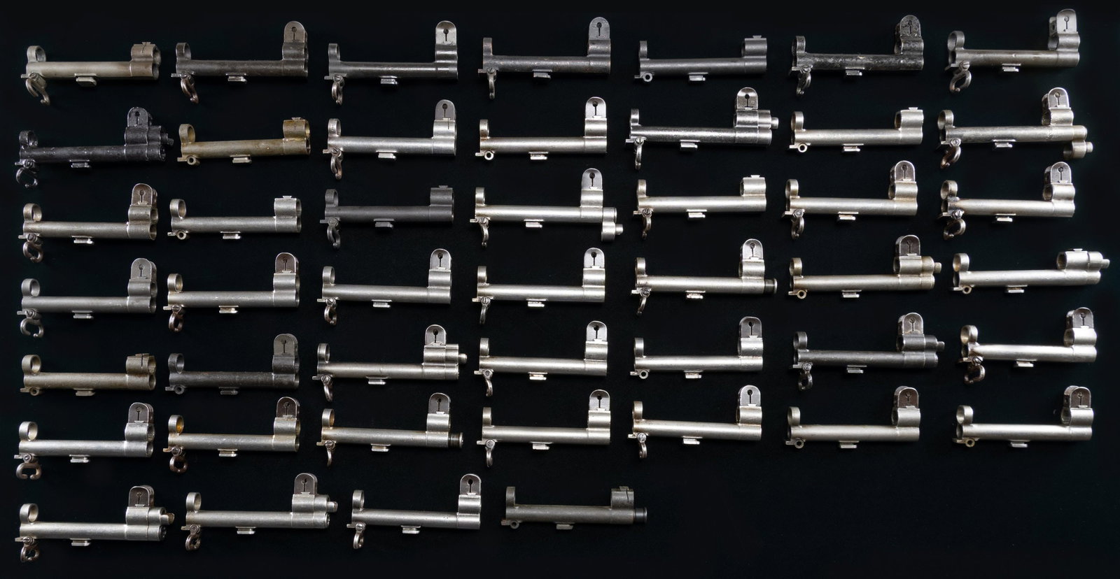 44 M1 GARAND RIFLE GAS CYLINDERS.: Many of the cylinders have front sights, stacking swivels, gas cylinder locks & gas cylinder lock screws. CONDITION: all appear to be used w/ moderate wear. Many have lost their original black or grey