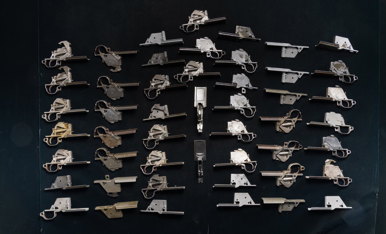 DESIRABLE GROUPING OF 49 M1 GARAND TRIGGER HOUSING: ASSEMBLIES AND STRIPPED TRIGGER GUARDS BY WINCHESTER, INTERNATIONAL HARVESTER CORPORATION AND HARRINGTON & RICHARDSON ARMS. No.1: Winchester. 16 complete trigger housing assemblies & 6 stripped trigge
