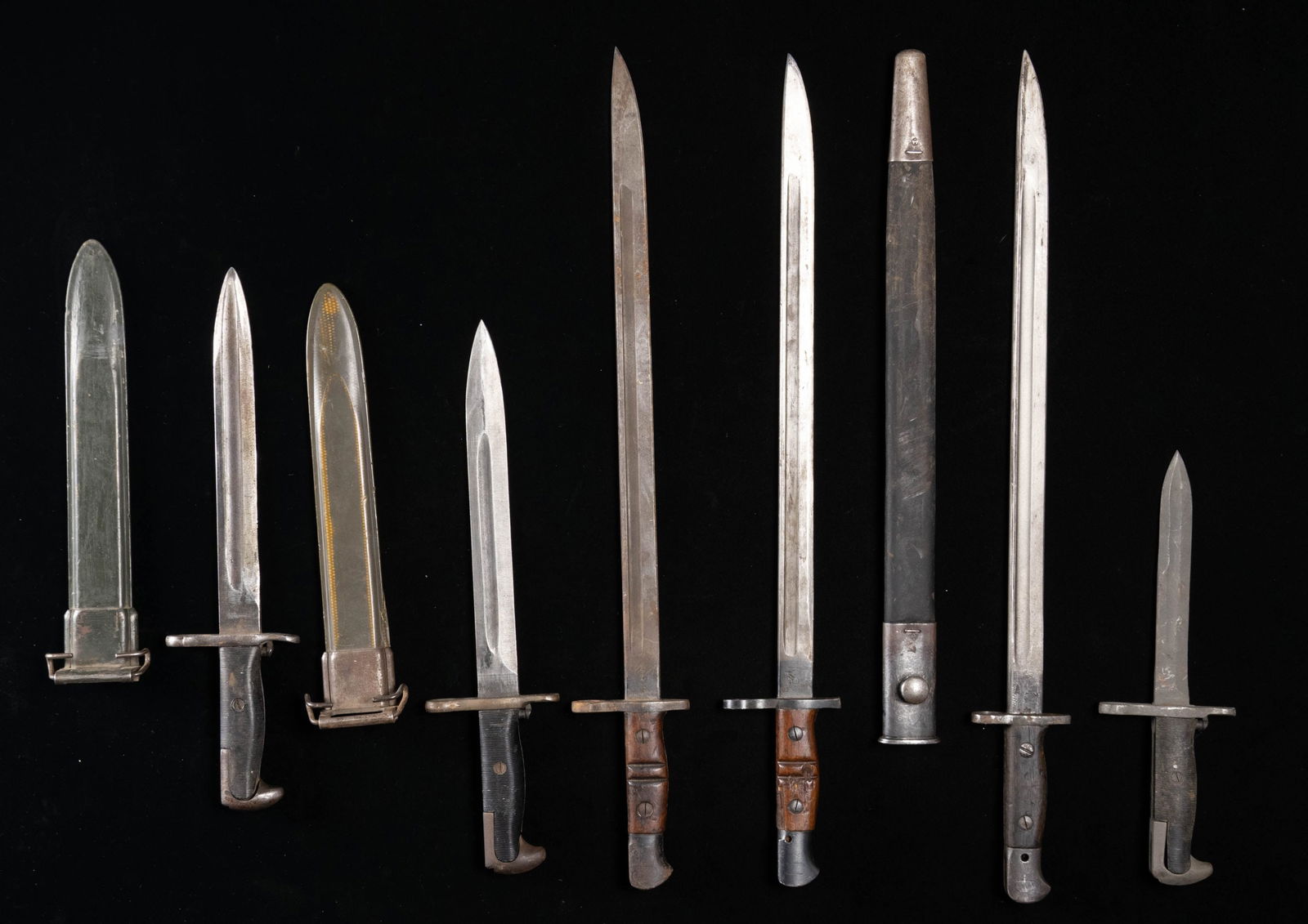LOT OF 6 US & BRITISH BAYONETS.: This lot consists of the following bayonets: 1) British P1907 bayonet. Bayonet has 1916 & 1934 dates but maker's marking is illegible. Scabbard present. CONDITION: metal parts of bayonet are mostly gr
