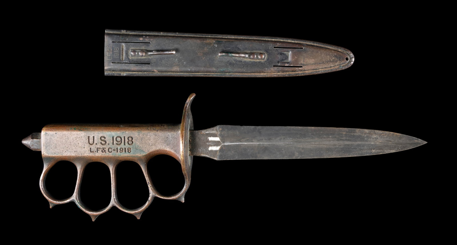 WWI LANDER, FRARY & CLARK US M1918 TRENCH KNIFE: WITH SCABBARD. Approx. 12" overall. Dbl. edged Blued blade length 6 3/4". Brass handle marked "U.S. 1918 / L.F. & C. -1918". Hexagonal pointed skull crusher nut at pommel. L. F. & C. 1918 scabbard. CO