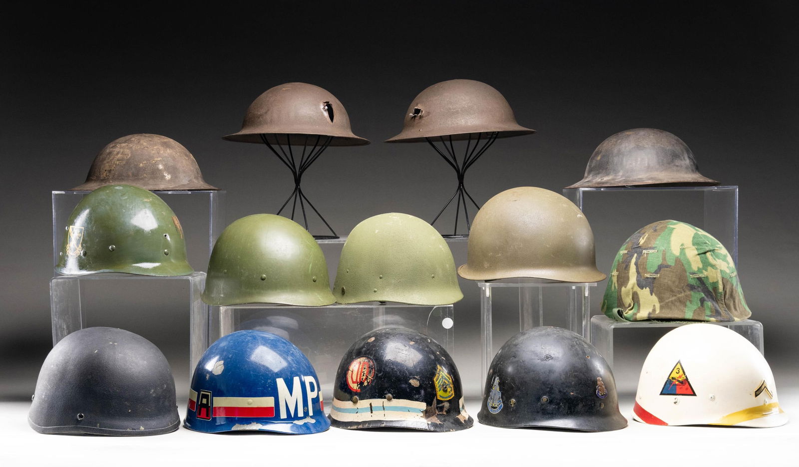 12 US HELMETS AND HELMET LINERS.: This lot includes 2 / "Shot Through" US M1917 helmets with no liners. We believe the helmets were recently shot through. 2 / US M1917 helmets with no liners. 1 / Post WWII US M1 style helmet with