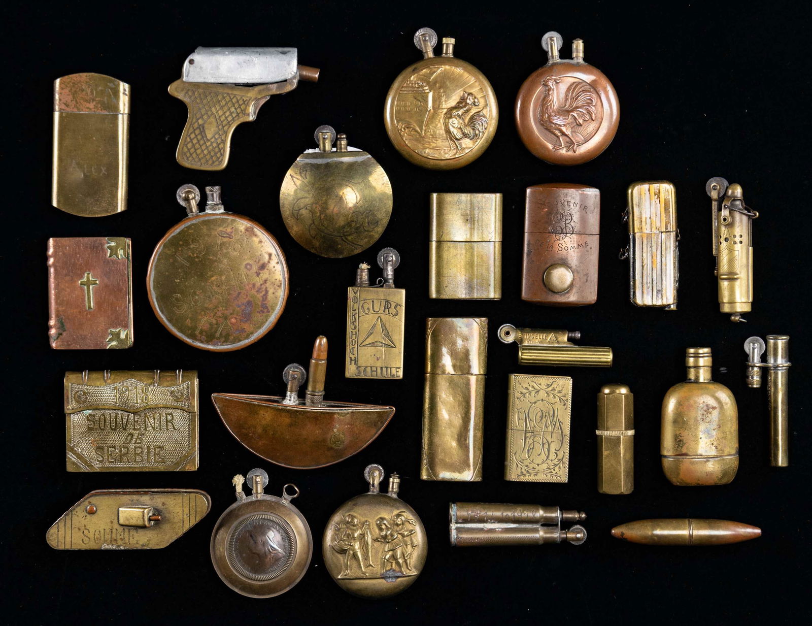 GROUP OF 25 WW1 FRENCH & GERMAN LIGHTERS.: Eclectic group of different shapes and designs, various battle sites engraved, some made from as trench art from discarded munitions. CONDITION: good to very good overall, most appear to function.