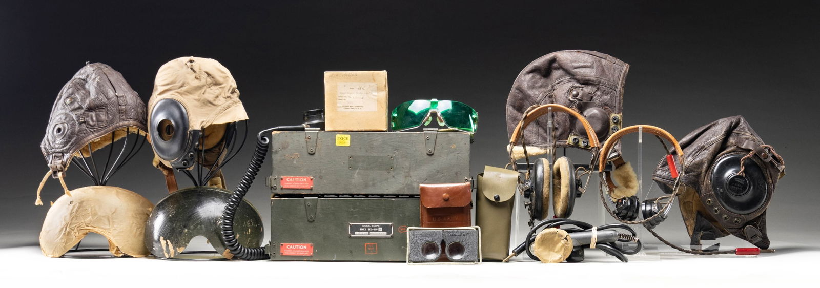 DESIRABLE GROUPING OF U.S. WWII VINTAGE FLIGHT: HELMETS AND RADIO EQUIPMENT. Grouping includes: No.1: brown leather flight helmet Type A-11, size medium complete with earphones and cord. In well-worn condition, but appears reasonably complete. / No