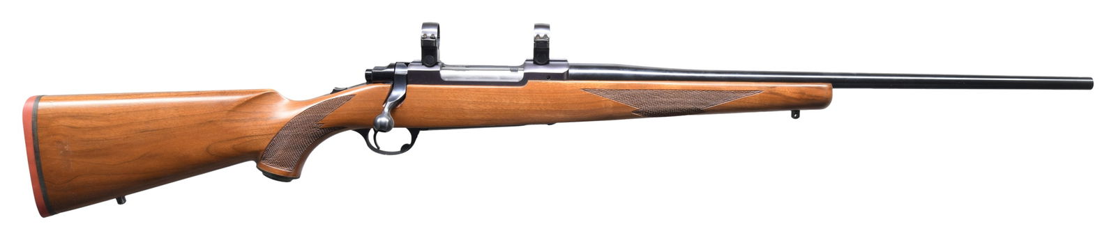 RUGER MODEL 77 BOLT ACTION RIFLE.: Cal. 7X57. S#. 70-40442. Bbl. 22" w/o sights. Action has top tang safety & Ruger rings. Walnut stock w/ cut checkering, swivel bases, grip cap & red pad. CONDITION: over 98% original blue. Stock finis