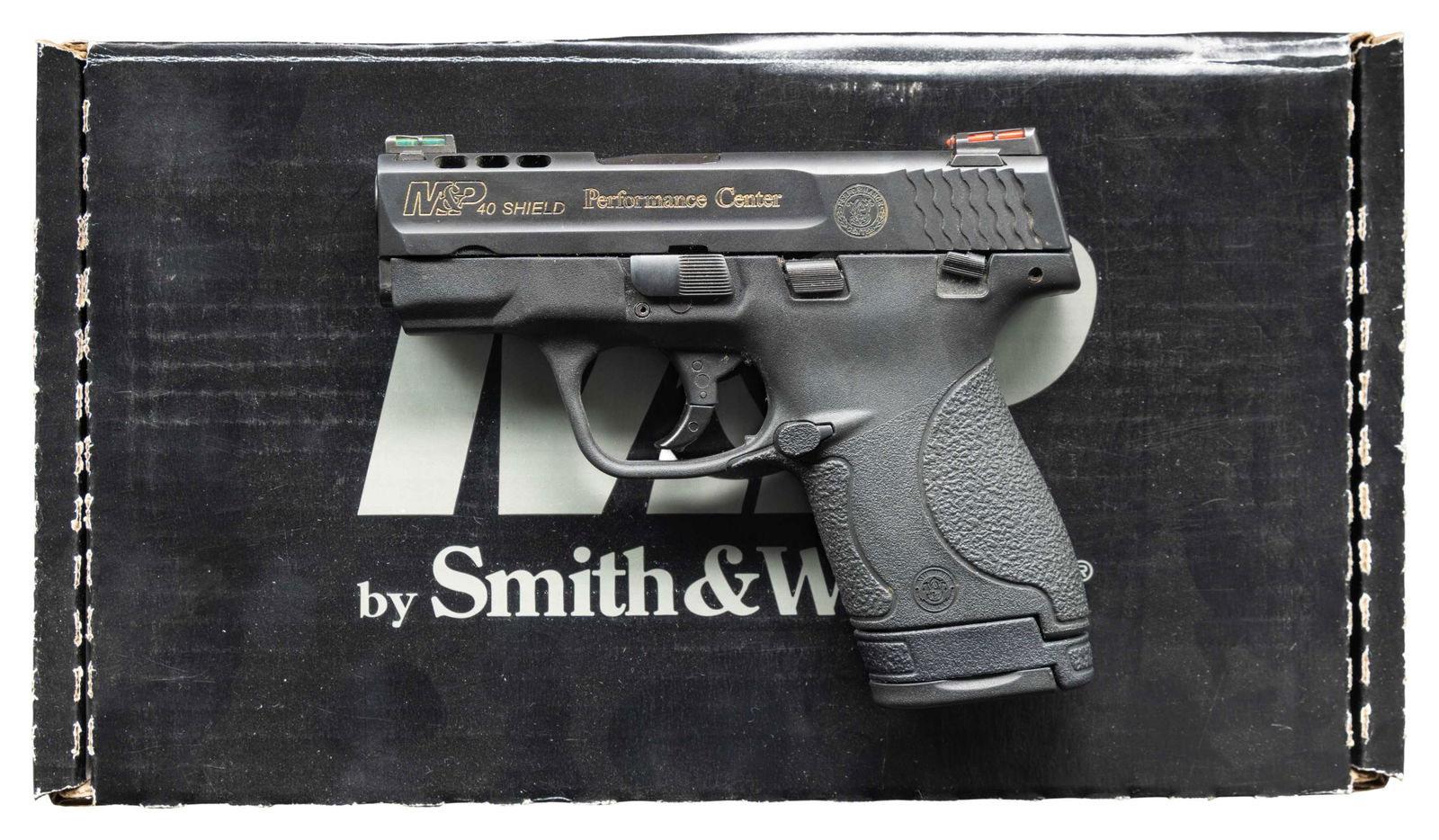 SMITH & WESSON PC M&P 40 SHIELD SEMI AUTO PISTOL.: Cal. 40 S&W. S# HMM1064. Bbl. 3 1/3". Fiber optic sights. Ported Performance Center M&P Shield pistol. Matte black finish. Various markings have added yellow highlight. Polymer frame. MAGS: 1-7 rd. &