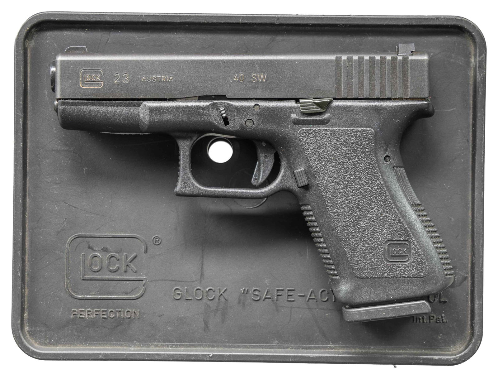 GEN 2 GLOCK 23 SEMI AUTO PISTOL.: Cal. 40 S&W. S# ARZ000US. Bbl. 4". Three dot Trijicon night sights. Aftermarket extended slide stop. Matte black finish. Polymer frame. MAGS: 7-13 rd. & 2-15 rd. Total of 7. UNATTACHED ACCESSORIES: ma