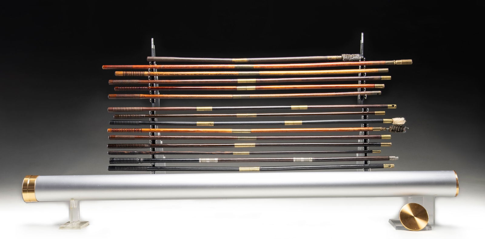GROUP OF CLEANING RODS.: 1) 15- Early cleaning rods for gun cases, mostly British and 2 piece: 6- Brass and light colored wood 2 piece. 5- Rosewood and brass 2 piece. 1- Ebony 2 piece. 1- Ebony 3 piece. 1- Short rosewood and