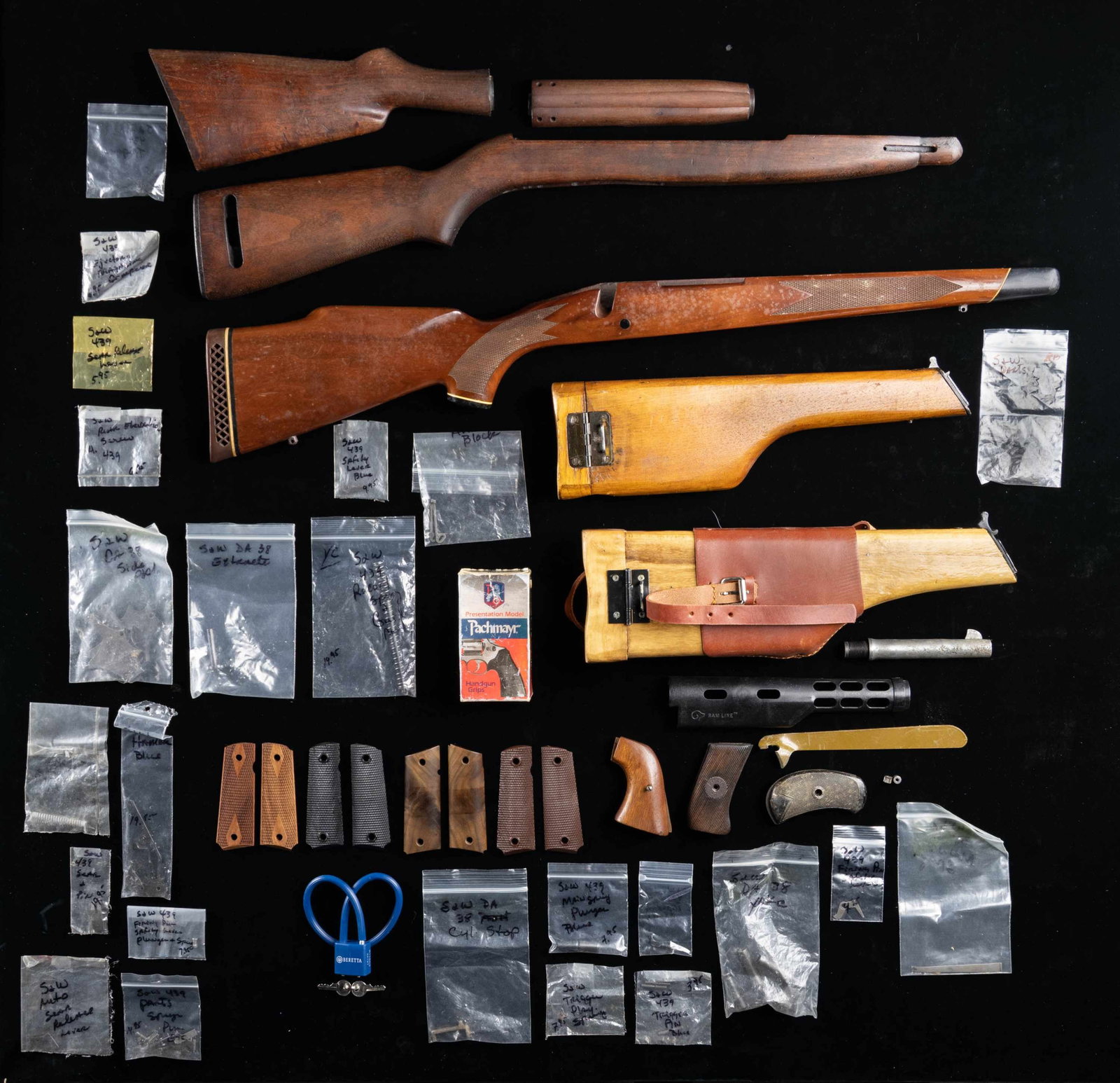 LOT OF ASSORTED FIREARMS STOCKS & ACCESSORIES.: Lot of assorted firearms stocks and accessories, including: 1) Checkered wood pistol grip stock, (appearing to be) for the Winchester Model 70. Black synthetic forearm tip and pistol grip cap. Buttsto