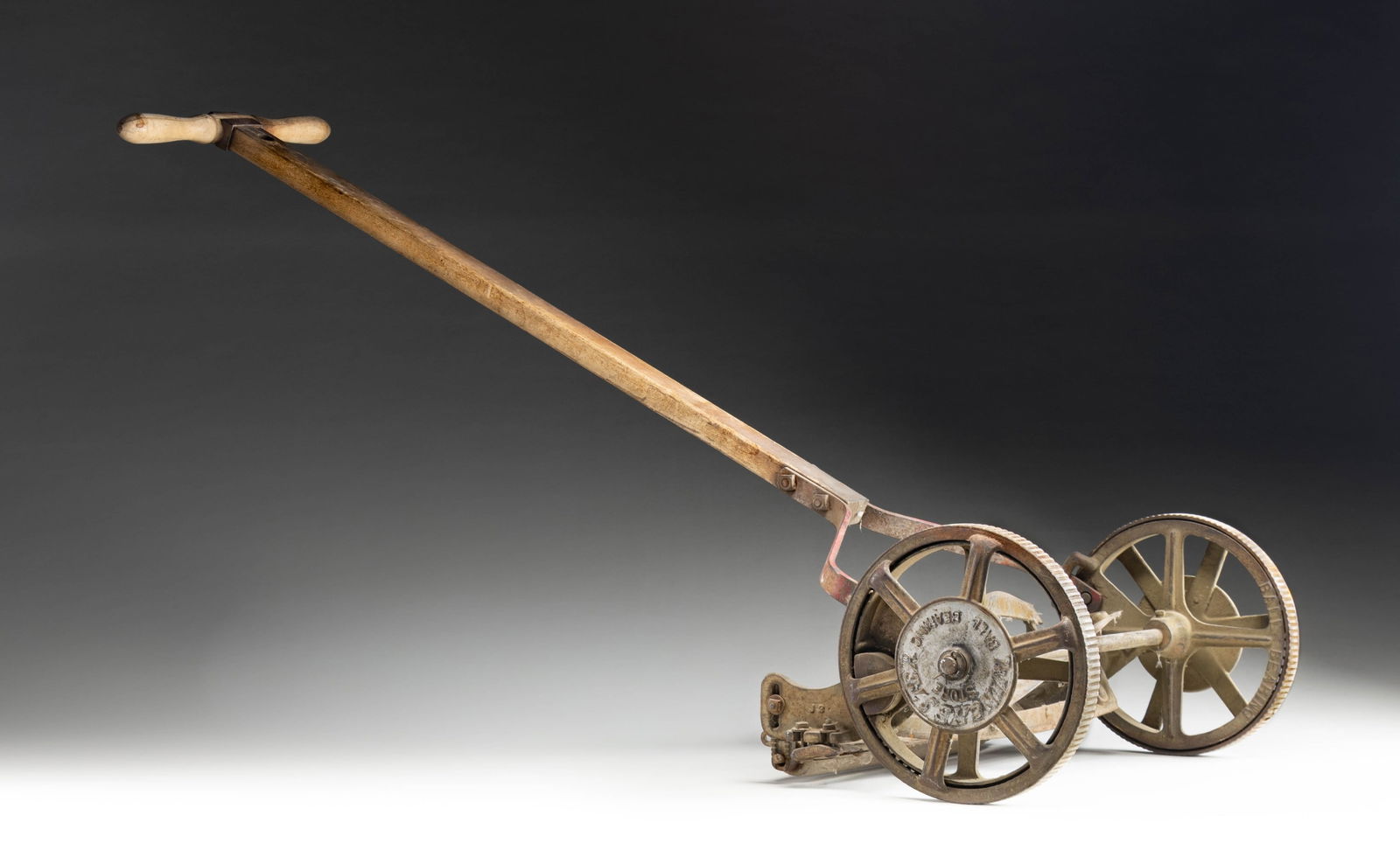 VINTAGE WINCHESTER REEL-TYPE LAWN MOWER.: Vintage reel-type lawn mower mfg. by Winchester. Cast iron construction with wood handle, shaft, and roller. Metal plate atop handle is marked "M/ 438". Front of shaft is faintly marked with what appe