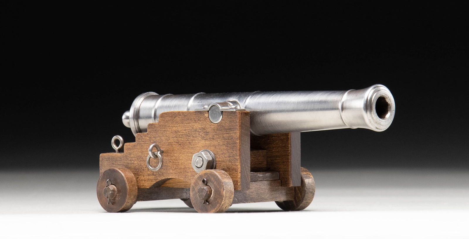 MINIATURE SPANISH CANNON WITH CARRIAGE.: Cal. 45 Rifled. NSN. Miniature steel cannon mfg. in Spain. Top of the cannon tube is marked "Black Powder Only" between 2 bands, with "SPAIN" marked on the underside. Polished steel construction with