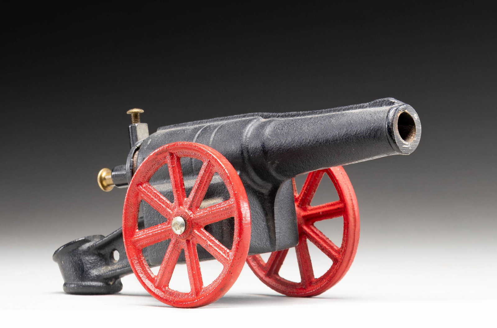 UNMARKED SMALL IRON FLINT STEEL CANNON.: Small flint steel cannon. Cannon is virtually unmarked, save for "PA TD" at the breech area and a "3" stamped on the left side of the trail. Cast iron construction with 2 brass heads at breech. Cannon