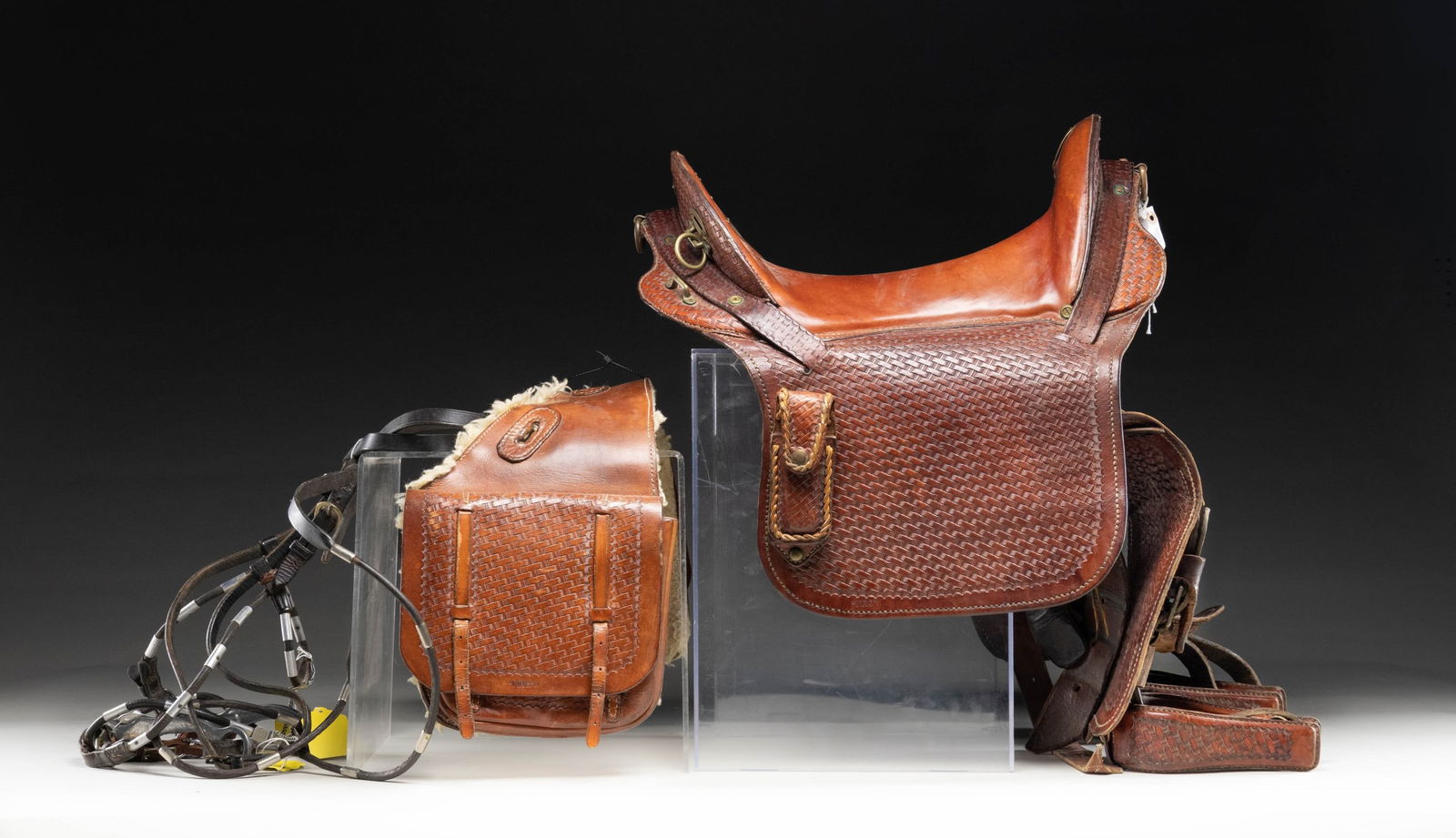 INDIAN WARS MCCLELLAN STYLE SADDLE.: Indian War era russet leather hand tooled McClellan type saddle. Saddle appears to be private purchase with more adornments than standard military saddles. Rear of saddle has brass shield marked