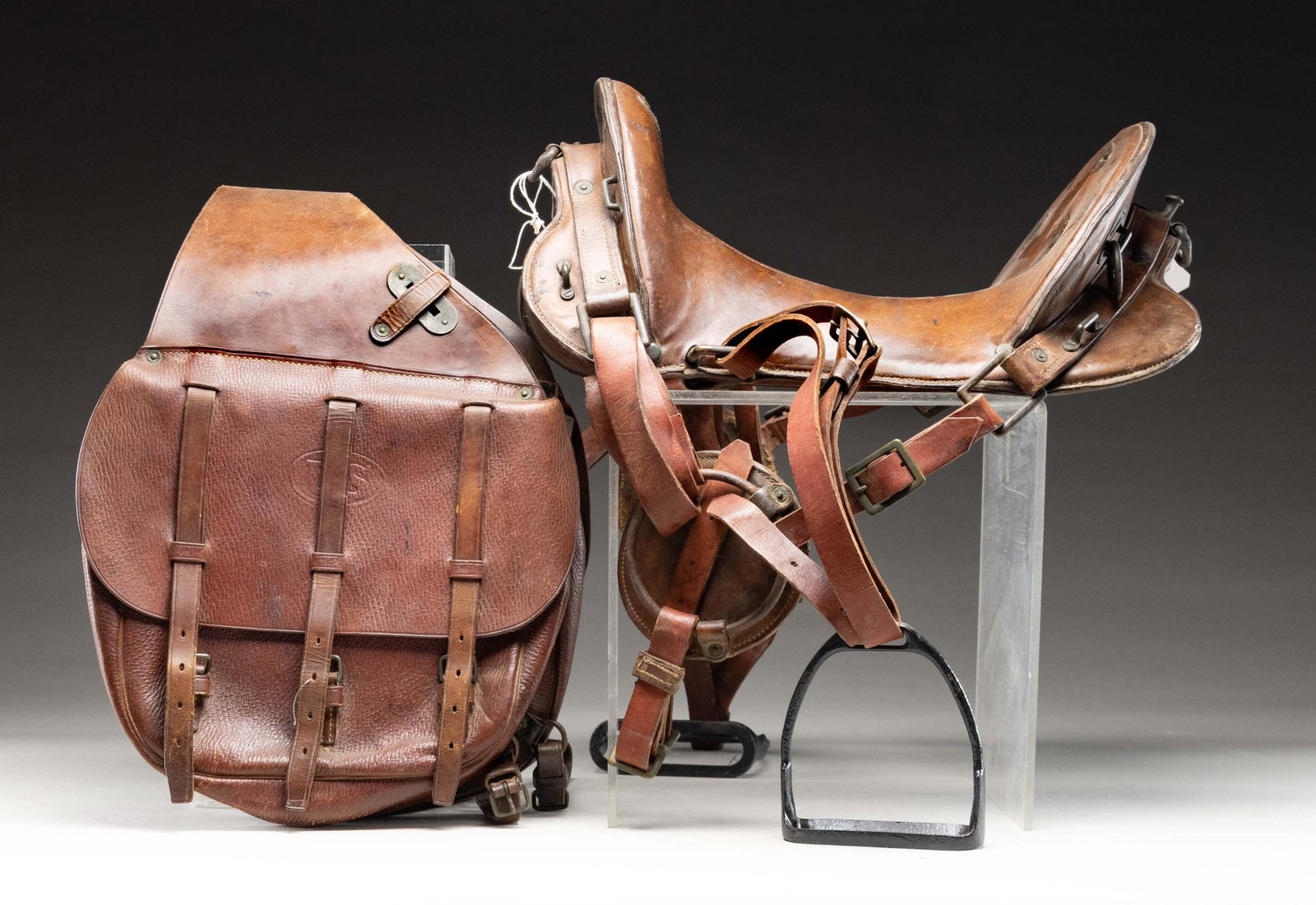 WW1 ERA MCCLELLAN SADDLE.: Russet brown leather saddle with 11" seat. 1918 dated McClellan saddle with "WSV" marking. 1918 dated US & Clinton marked saddle bag present. CONDITION: leather shows scattered age related wear, light