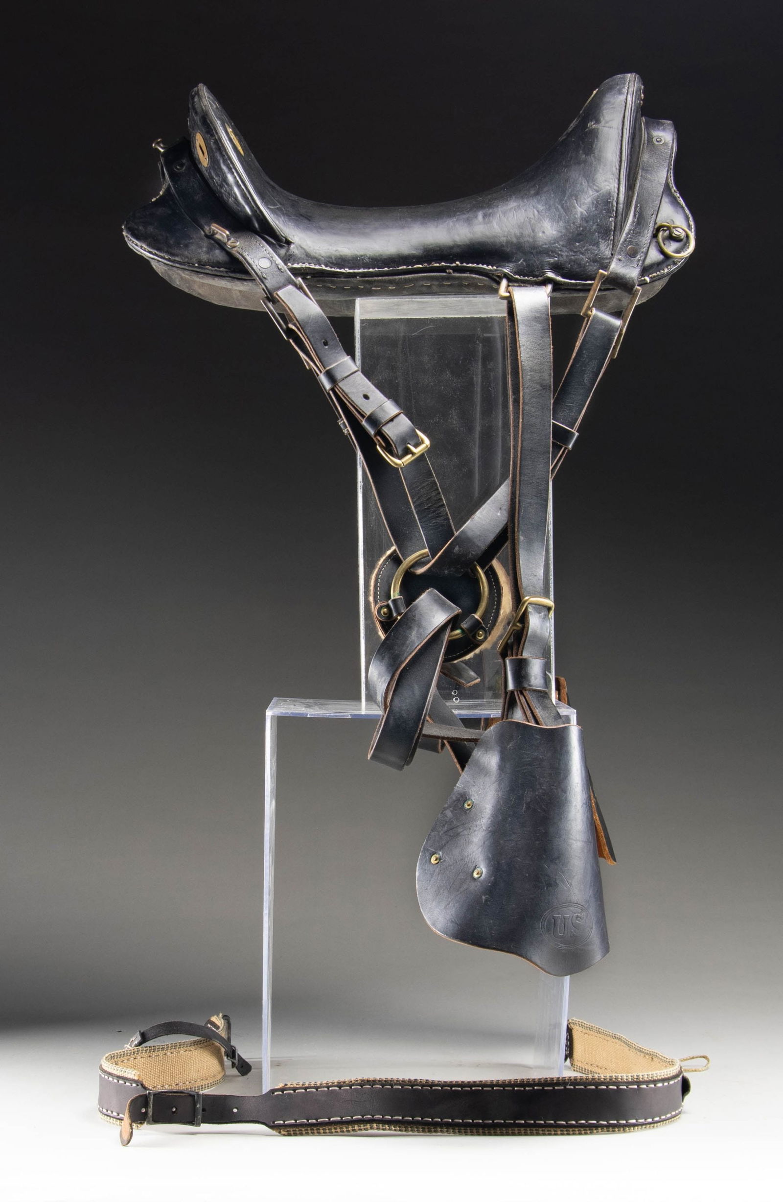 MILITARY STYLE BLACK LEATHER SADDLE.: Measures approx. 21" length with black leather having stitched seams. Saddle appears military style, but shows no maker's marks. Seat has a few slots for leather straps with brass escutcheons. Comes w