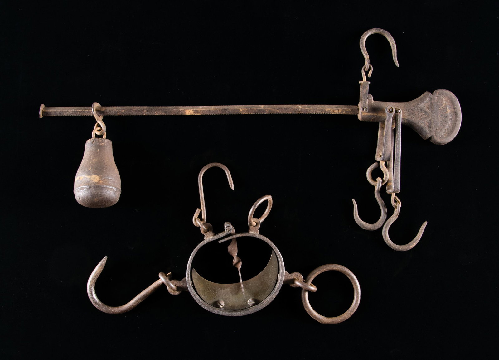 2 ANTIQUE SCALES.: This lot contains 2 antique scales. The first is a cast iron balance beam scale with 3 original hooks and counterweight. the other is a scarce buffalo hide scale used by hunters to weigh buffalo hides