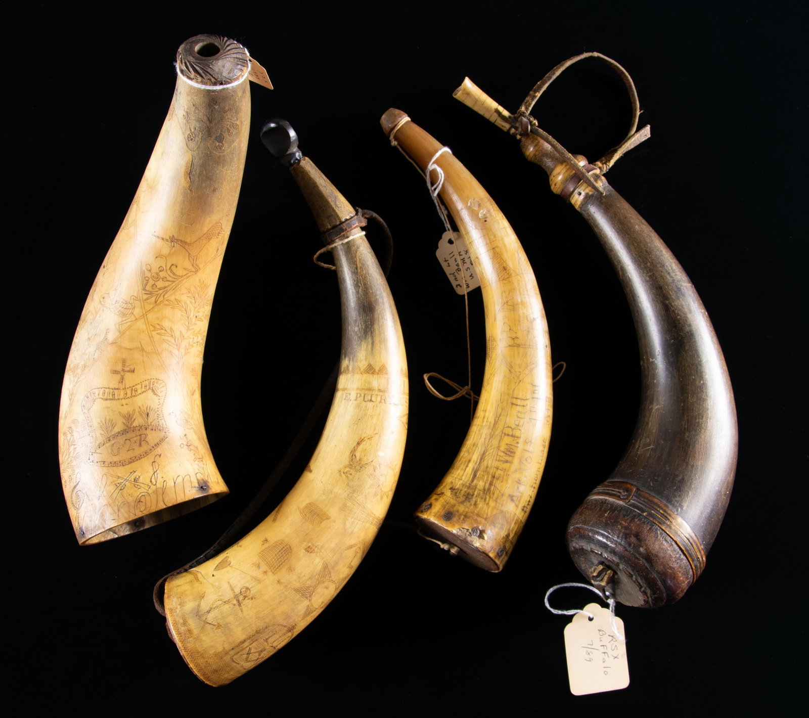 FOUR SCRIMSHAWED POWDER HORNS.: 10" 18th century fully carved with King George II crown, missing plug, carved name around base, hunter and deer, unicorn, fountain, flowers, bird; 12" "1811 E PLURIBUS UNUM", "FM" nicely carved on plu