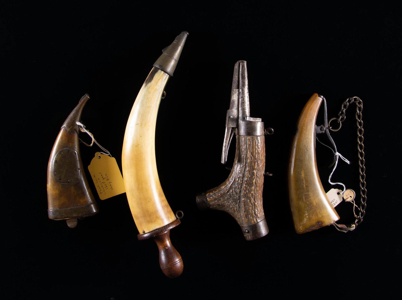 GROUP OF EARLY 18TH & 19th PRIMING HORNS.: 7" flat horn dated 1800 on base band, brass mounted with forged spring loaded charger; 8" flat horn with forged iron charger, light scrimshawed design and date 1844; 10" stag of wheellock era, 5" forg