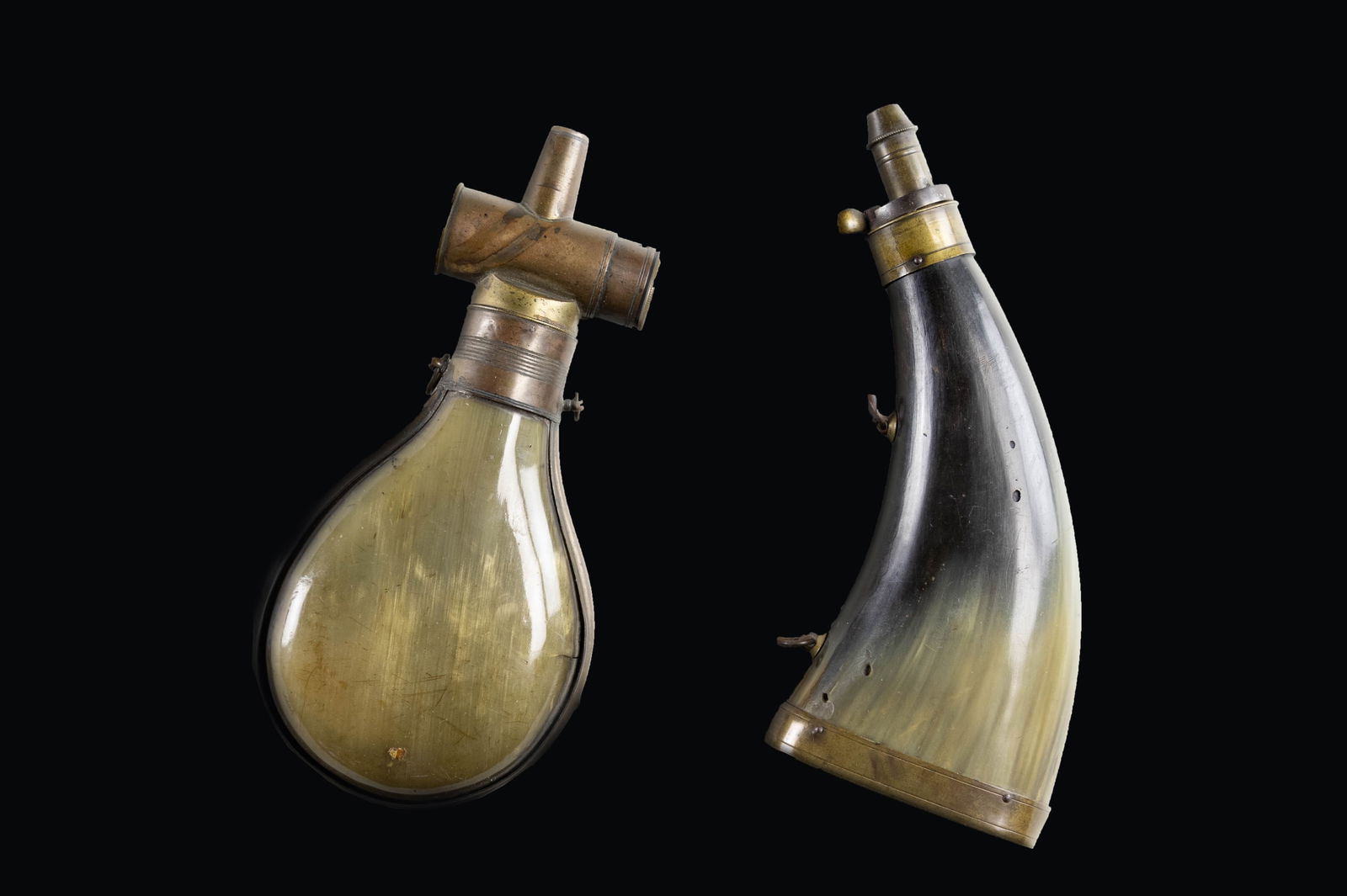LOT OF TWO BRITISH POWDER FLASKS.: This lot consists of the following powder flasks: 1) British Bag Flask. Adjustable powder measure. Appears to be mid 19th century. Overall length 7 1/2" from top to bottom. Horn body. Brass hardware.