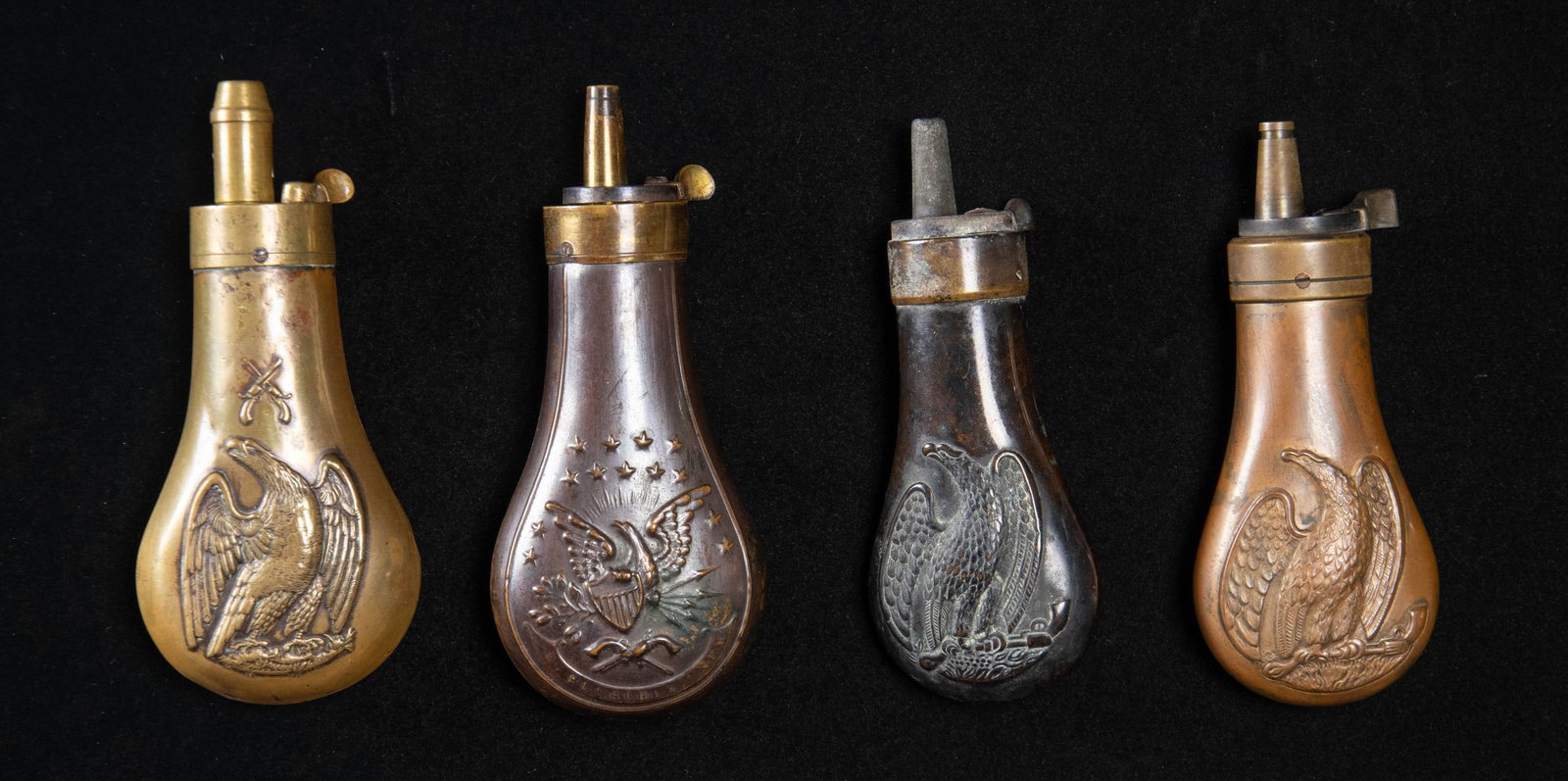 FOUR EAGLE PISTOL FLASKS.: 4"-4.5", Riling 754, 760, 765 dented, 767. CONDITION: good to very good overall. (02-25908/JS). NON-GUN. $350-550.