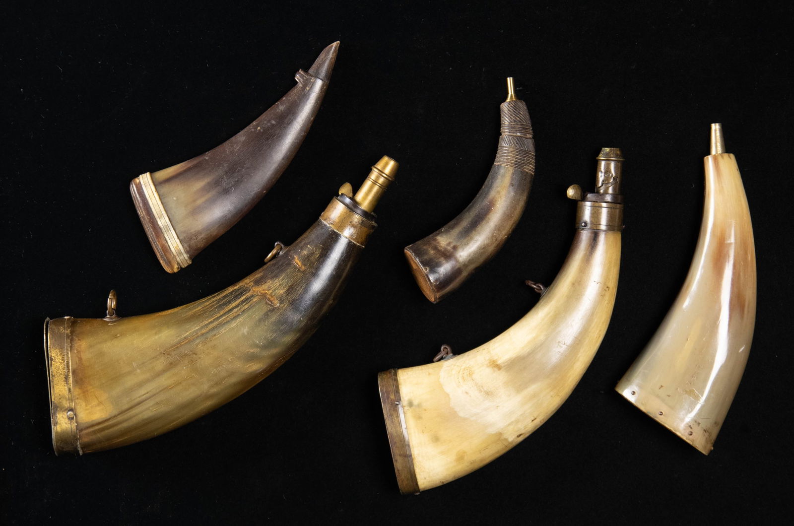 GROUP OF 5 VINTAGE "LIBERTY CAP" SHAPED POWDER: HORNS. Ranging from 6" to 8", variant construction, 2 have brass butt caps & chargers. CONDITION: 3 are good to very good overall, other 2 have reproduction charger parts. (02-25916/JS). NON-GUN.