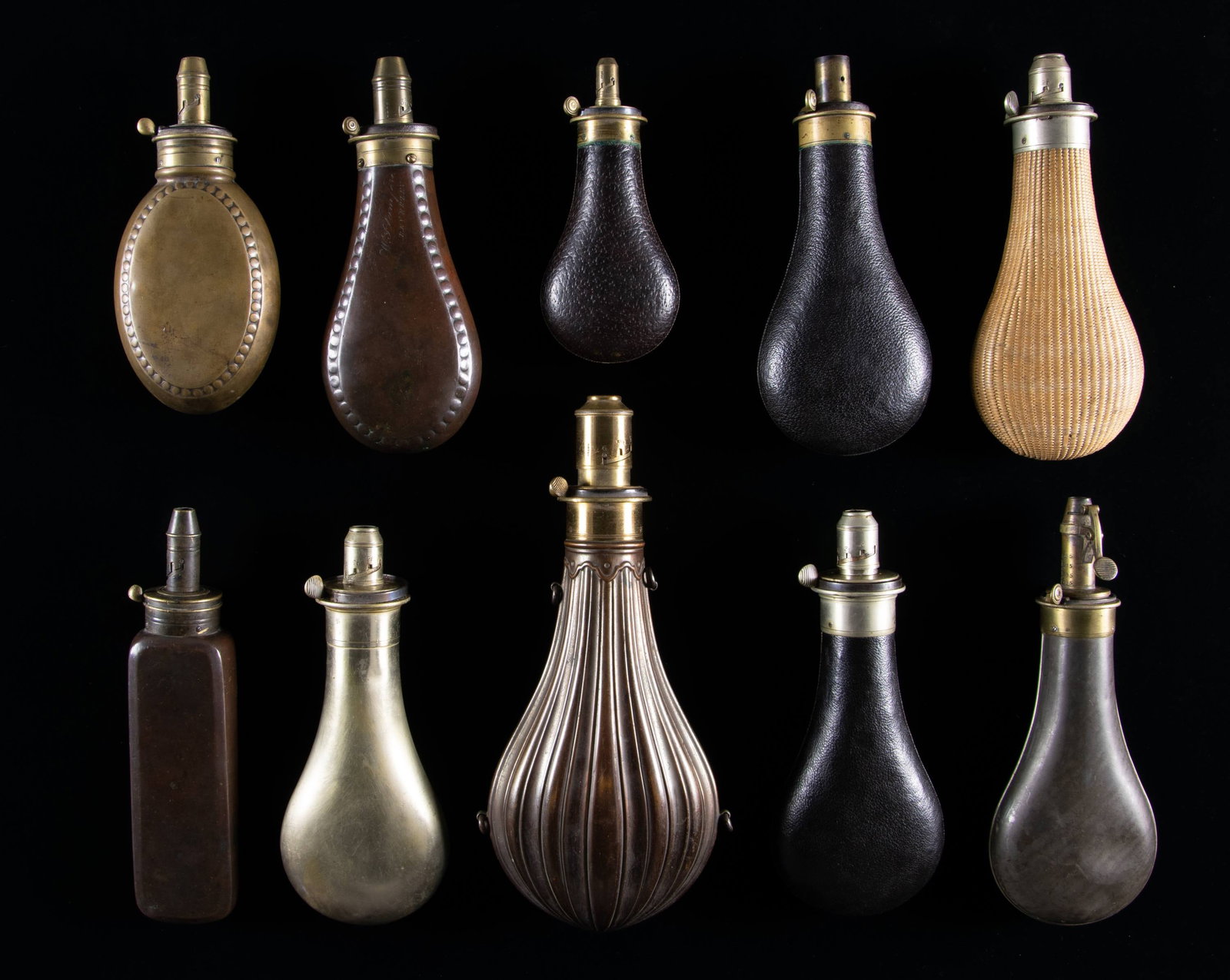 10 SYKE'S PATENT POWDER FLASKS.: Thomas Sykes and family are among the earliest powder flask manufacturers in Sheffield. Several rarely seen varieties of "Syke's Patent" rifle & shotgun flasks: three 6", 7", 8" leather covered, 8" Ge