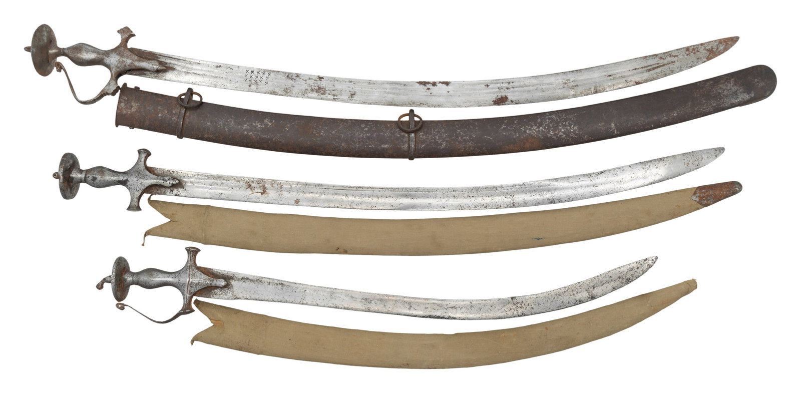 THREE 17th-18th CENTURY INDIAN TULWAR SWORDS.: Swords are classic Northern Indian design, each with variant steel guards, blades measure from 23-31"; the largest has 3-fuller decorated blade and incorrect European steel scabbard, two have heavily