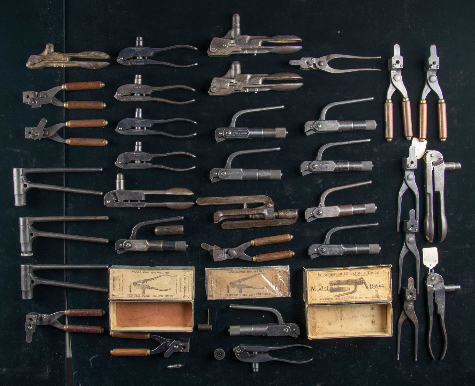 VERY LARGE DESIRABLE GROUPING OF WINCHESTER: RELOADING TOOLS & BULLET MOLDS. 1) Three Winchester Model 1875 reloading tools; one is marked "45-75 W.C.F.", one marked "45. GOV."; each having worn finish turning gray, and one with remnants of its