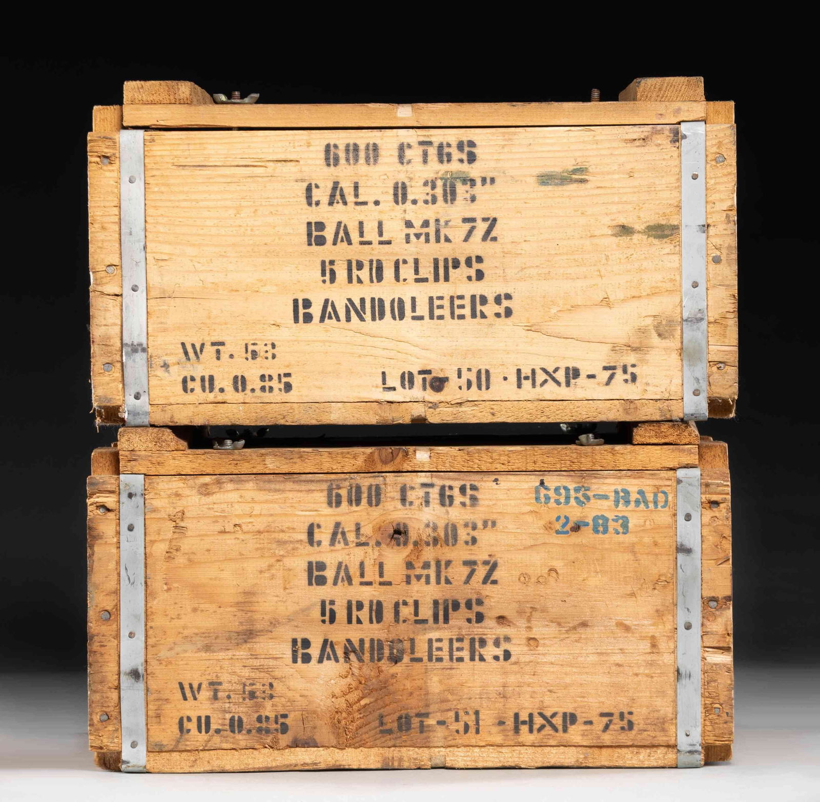 1,200 ROUNDS OF 303 BRITISH AMMO IN SEALED CANS.: 2 wooden crates containing 4 cans having 300 rounds each. Marked "MK7Z" and "HXP-75". Contents are on 5 round stripper clips in 50 round bandoliers. Crates are very good. (02-25027-17/NW). $500-750.