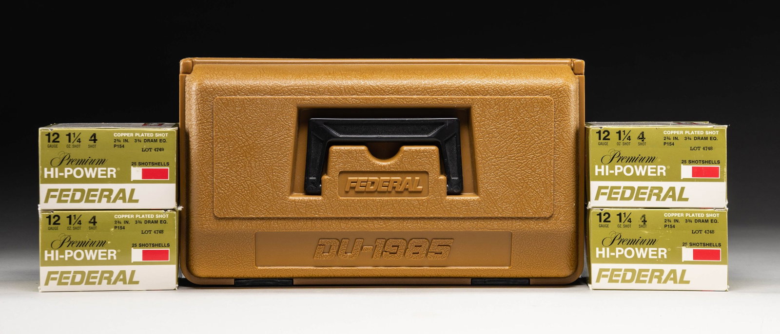 FEDERAL DUCKS UNLIMITED 1985 EDITION AMMO CASE: WITH AMMUNITION. Ducks Unlimited brown synthetic ammunition case produced by Federal circa. 1985. Exterior of lid is marked "FEDERAL" above "DU-1985". Case contains x4 boxes 25-rd. boxes (100-rds. tot