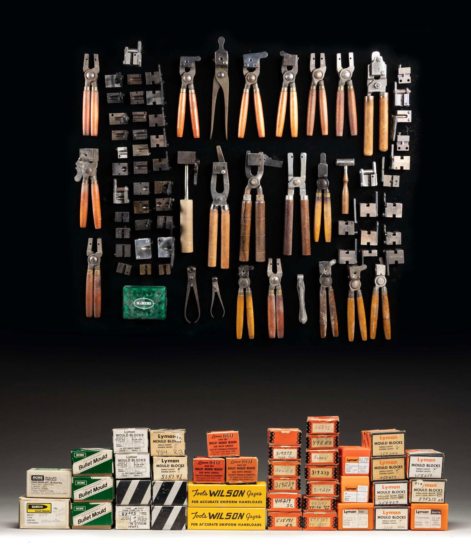 LARGE LOT OF BULLET MOLDS: This lot consists of the following items: 1) About 12 loose varied moulds with handles. 2) About 38 boxed bullet mould blocks mostly Lyman with some RCBS. 3) About 12 loose mould blocks without handle