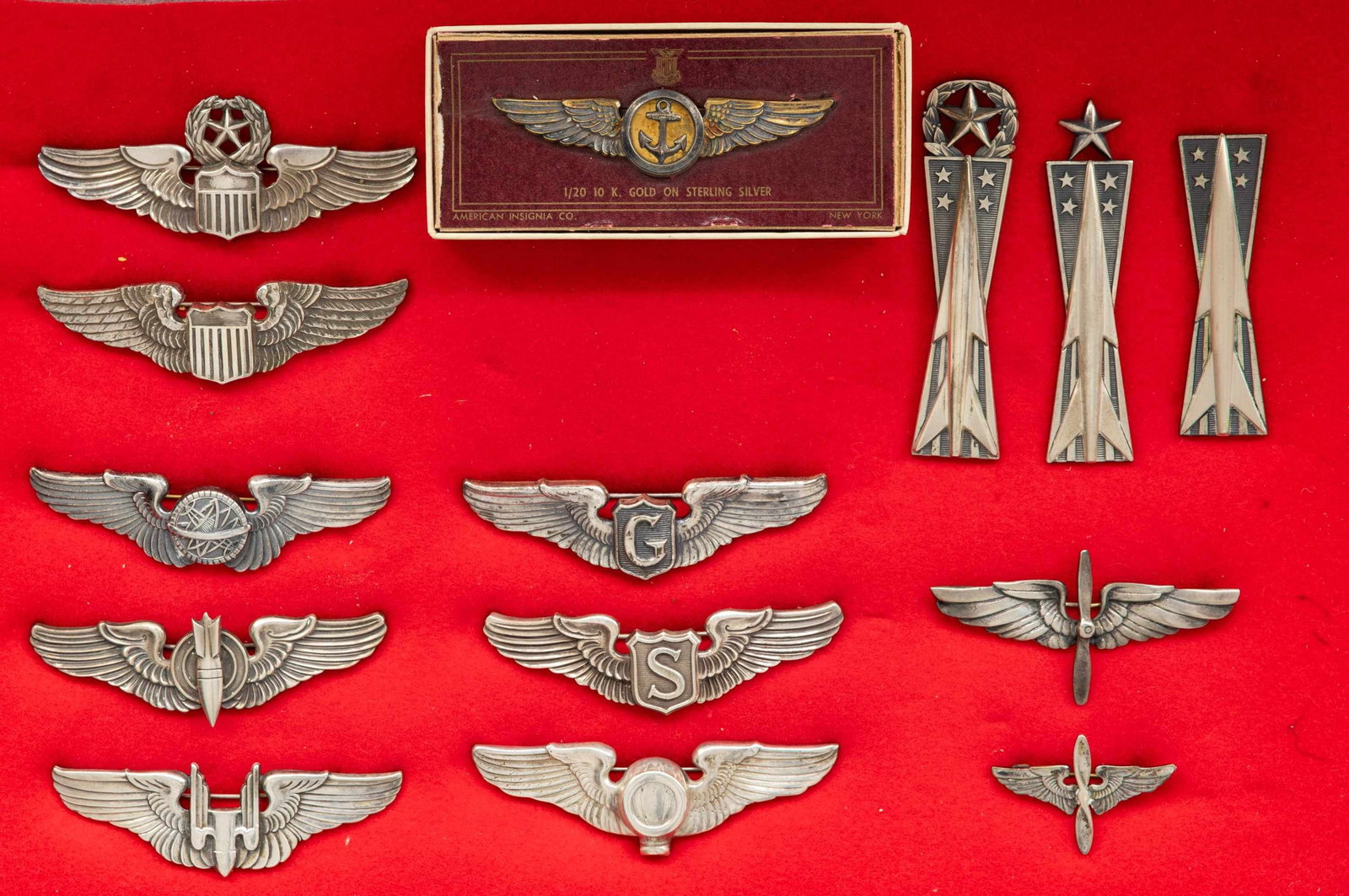 US FLIGHT WINGS AND MISSLE BADGES.: This fine lot of sterling insignia includes 1 Army Air Corps command pilot wing, 1 Army Air Corps pilot wing, 1 Army Air Corps navigator wing, 1 Army Air Corps bombardier wing, 1 Army Air Corps
