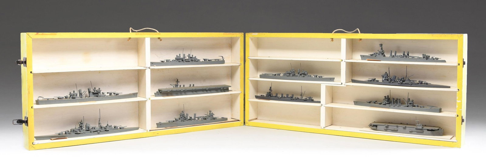 WWII NAVAL SHIP IDENTIFICATION MODELS IN THEIR: ORIGINAL DIVIDED WOODEN CASE. This group represents a variety of ship identification models of the WWII era produced by the United States. They are housed in a rare folding wooden case measuring 37"
