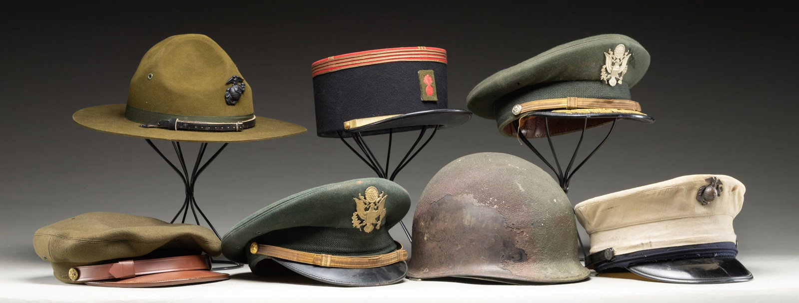 GROUPING OF MILITARY HEAD GEAR.: 1) U.S. M1 Combat helmet with liner. 2) U.S. Army Officer's cap by Berkshire.3) U.S.M.C. Enlisted visor cap (WWII).4) French Officer's kepi with added patch.5) U.S. Army Enlisted visor cap with remove