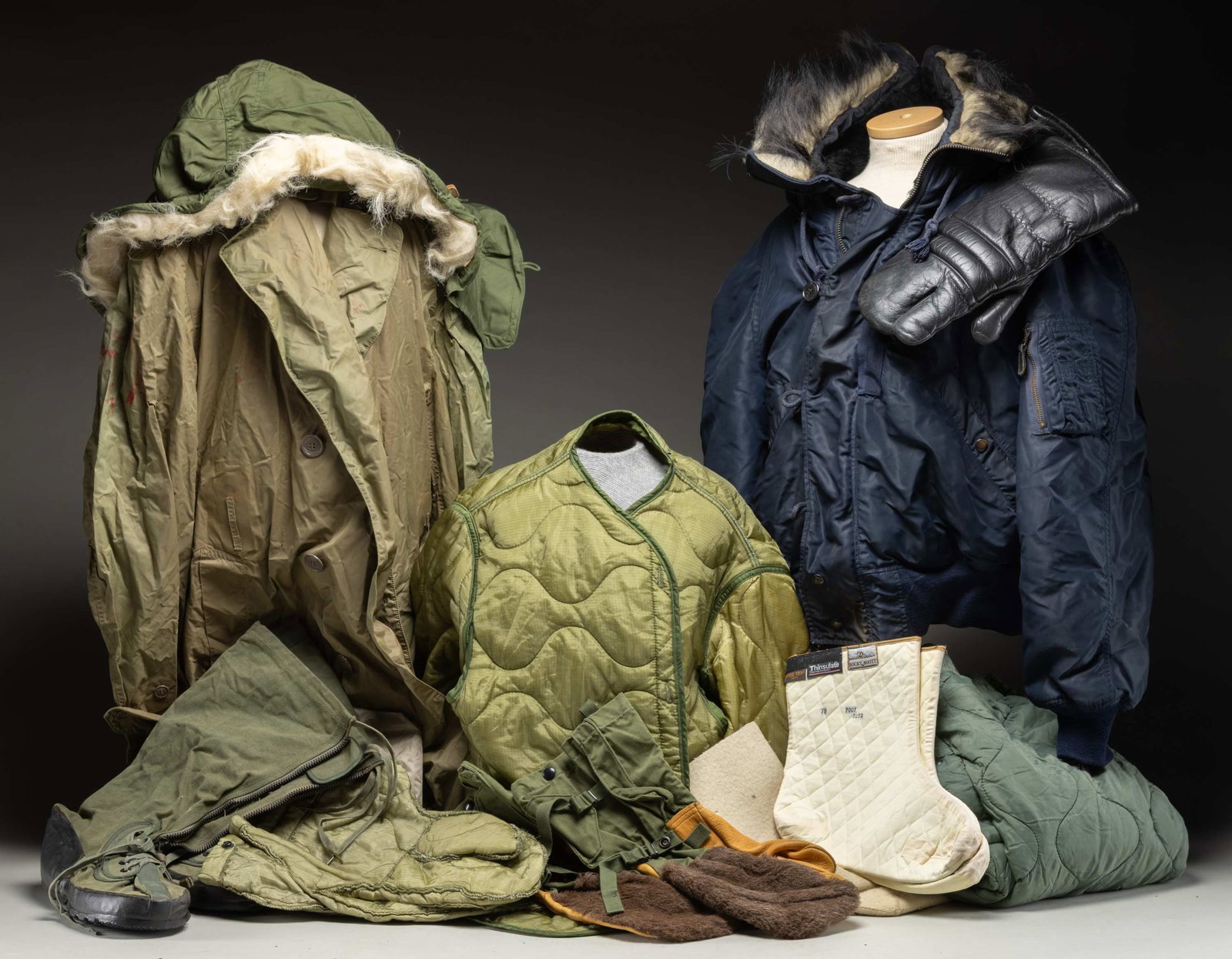 GROUPING OF U.S. FOUL WEATHER GEAR.: 1) Vietnam era U.S. cold weather coat liner.2) 1958 U.S. men's rain jacket.3) Cold weather mitten liners.4) Men's Flyer's trouser liner.5) Navy heavy Type N-2A flying jacket.6) Cold weather parka