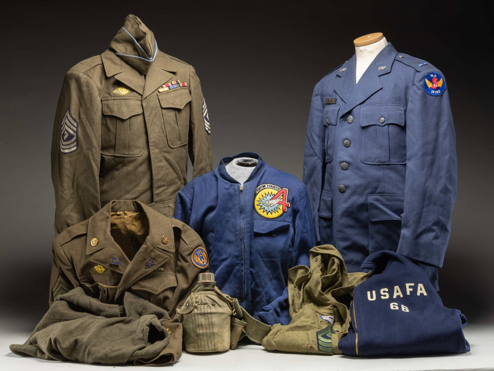GROUPING OF U.S. UNIFORMS & CLOTHING.: 1) U.S. Army Ike jacket of a 1st Sgt. of the U.S. 8th Army with 1 year of overseas service bars and 3 year service bar, 5 ribbon award bars and a Ruptured Duck.2) U.S. Army wool uniform shirt of a