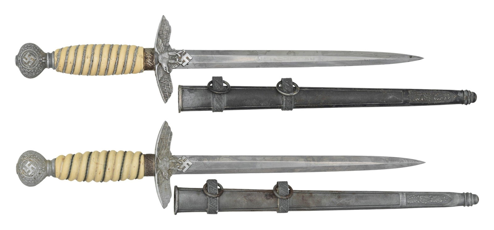 2 SECOND MODEL LUFTEWAFFE DRESS DAGGERS.: 1) F.W. HOLLER. This dagger is maker marked on the obverse. It has a relief carved oak leaf quillon that is appropriate for Holler. The pommel is a fine detailed pebbled background WKC with two