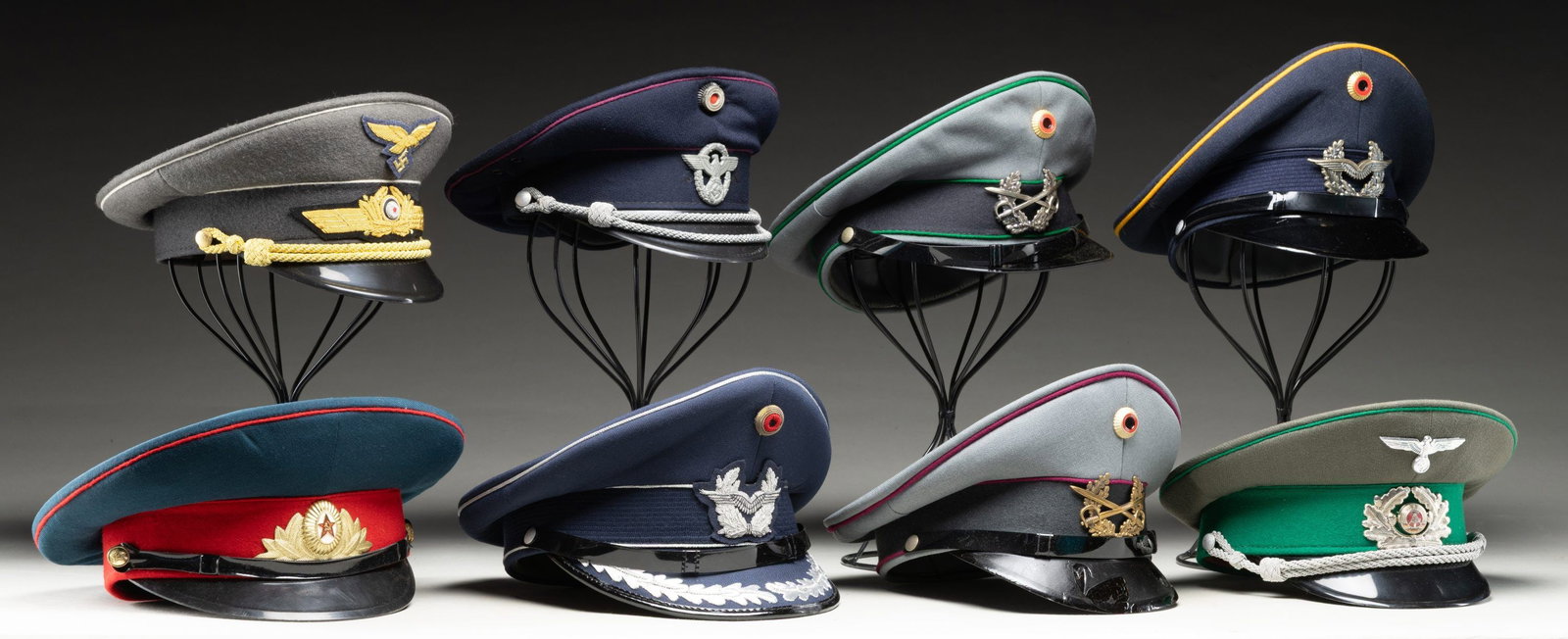 LOT OF 8 PRIMARILY GERMAN REPRODUCTION OFFICERS: CAPS. Lot of 8 primarily German reproduction officers caps, including: 1) Reproduction Third Reich fire police officers visor cap. 2) Reproduction Luftwaffe General Officers visor cap. 3) East German